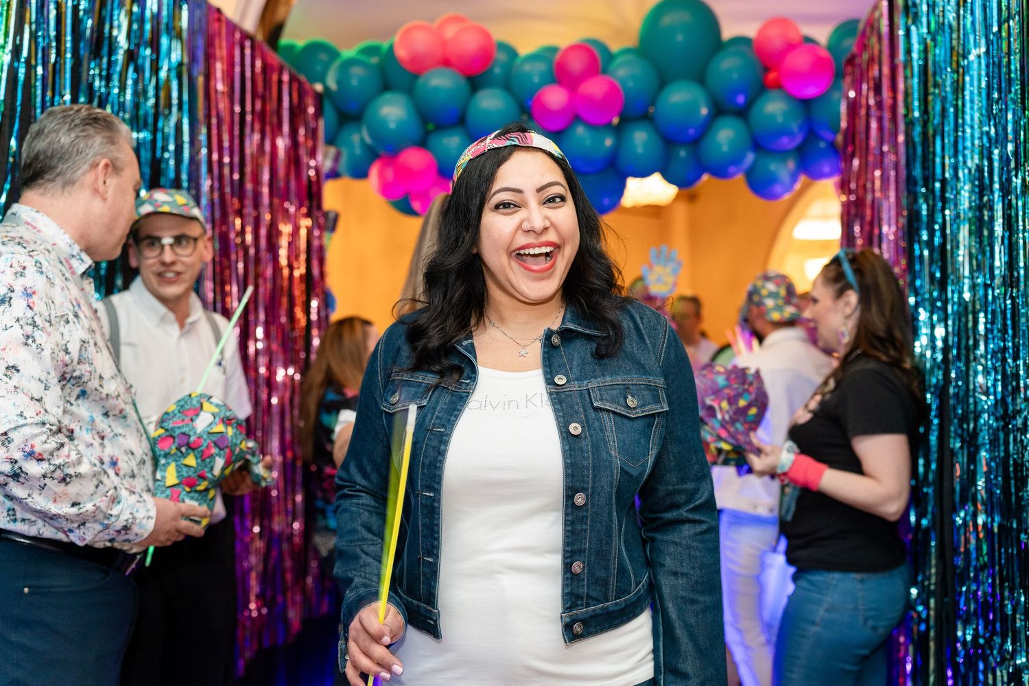 Festive celebration with balloons and metallic streamers creating a vibrant party atmosphere.