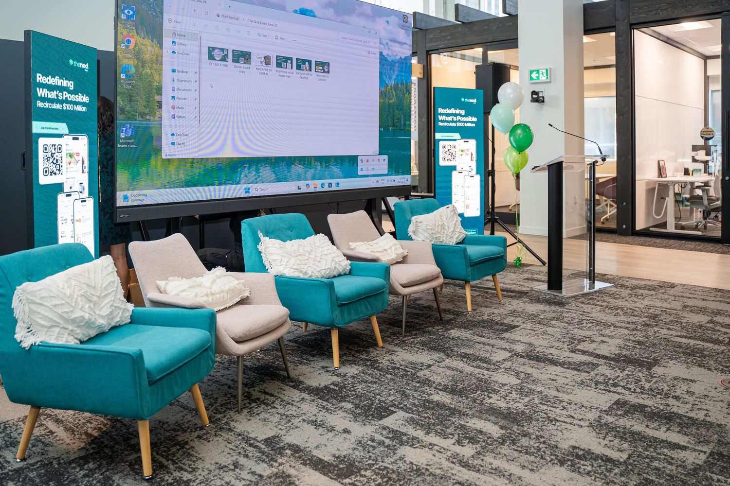 Modern office space with teal accent chairs and carpeted floors showcasing a professional waiting area.