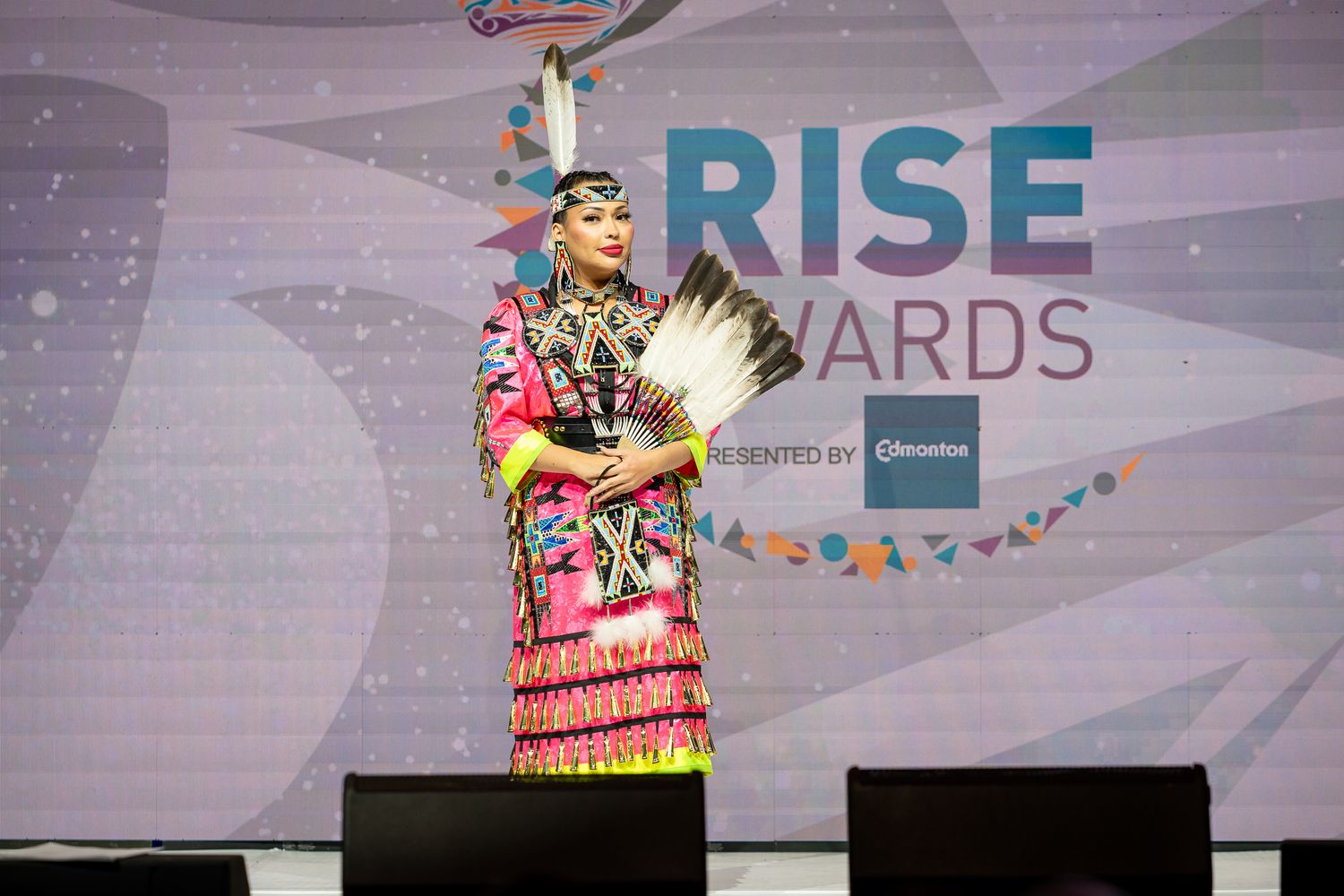 RISE Awards stage setup with colorful lighting and presentation screens.
