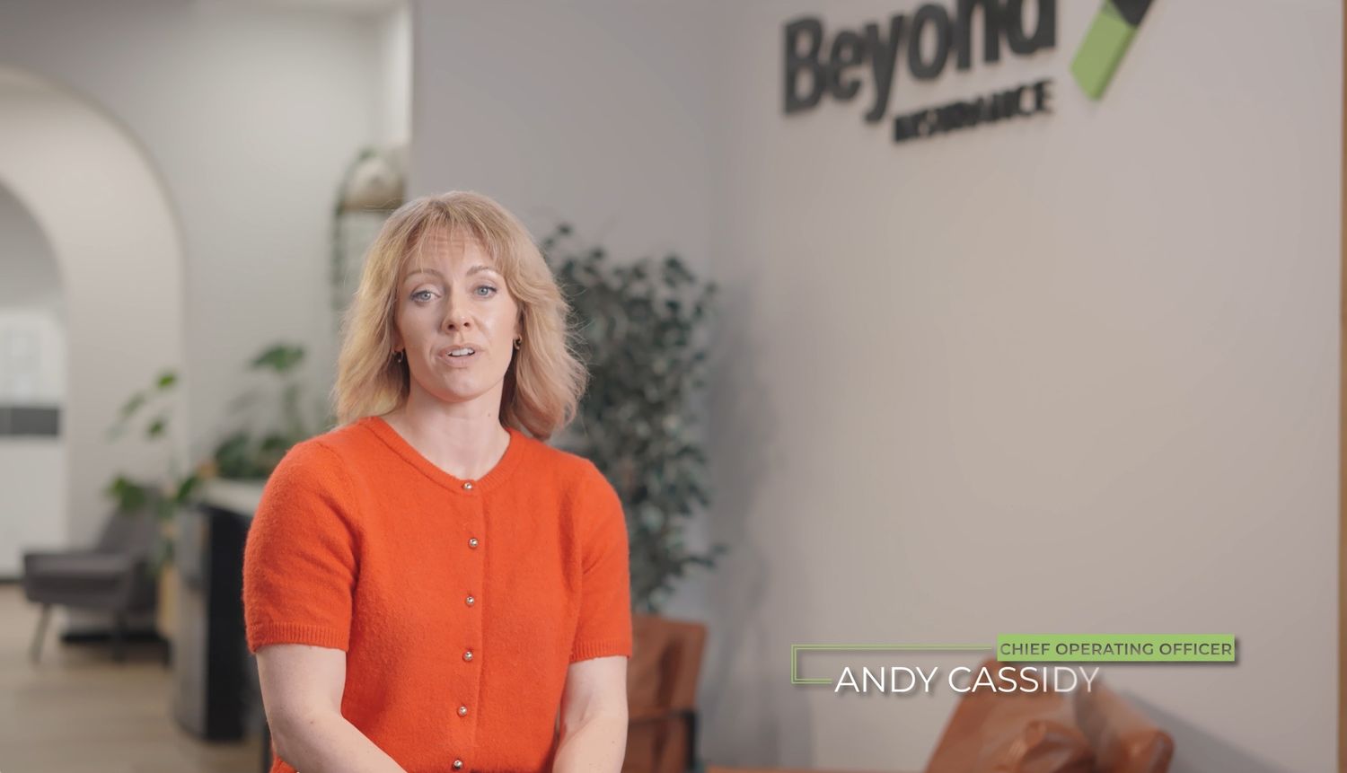 A series of five connected images showing a person in bright orange clothing in different office settings.