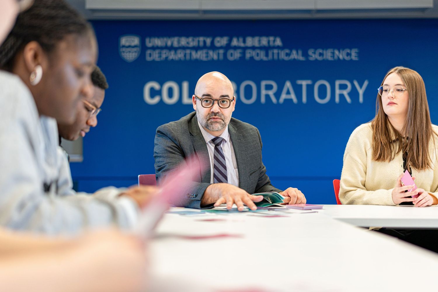 Group discussion in University of Alberta Political Science collaborative workspace.