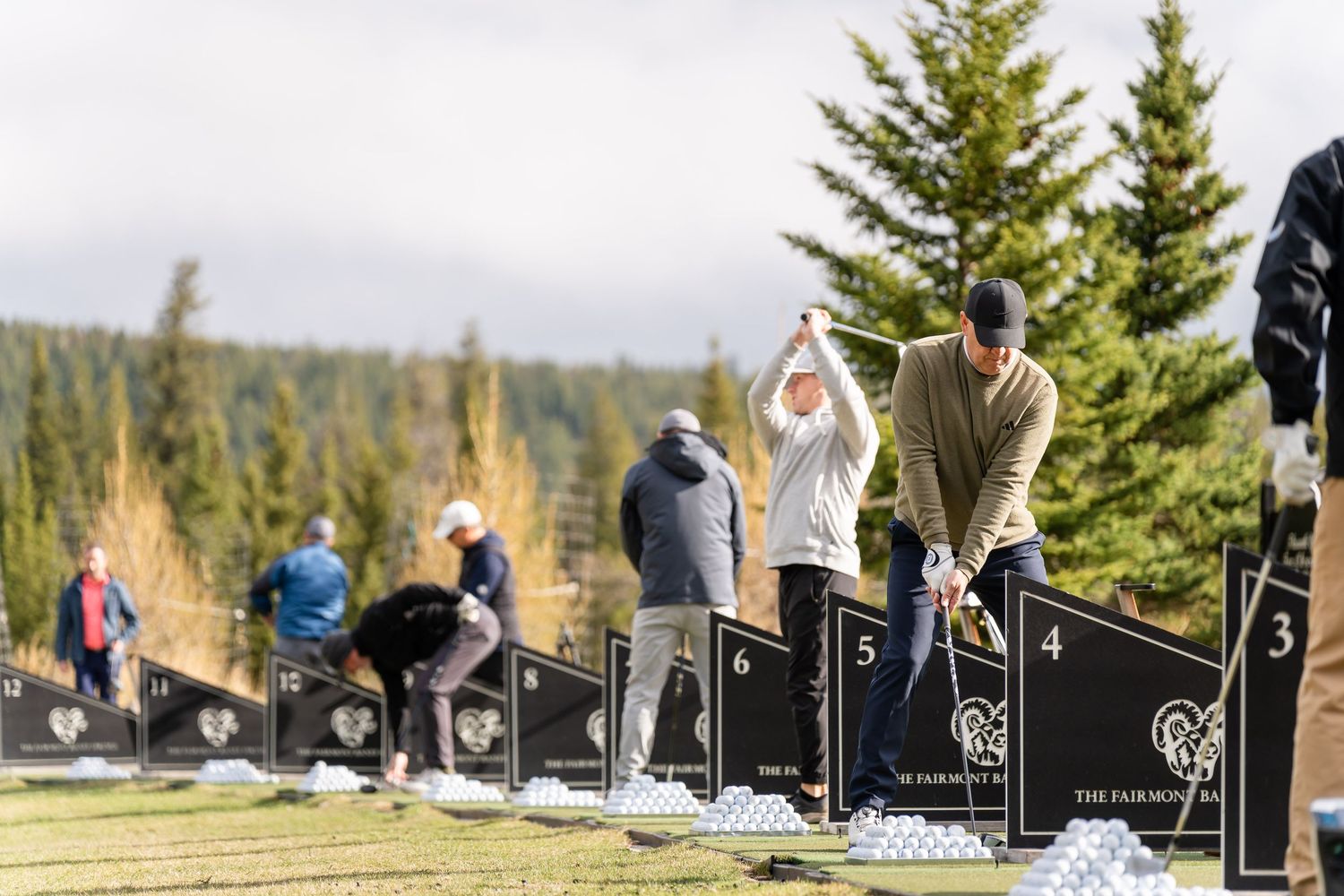 Golf course markers and tee boxes lined up against mountain landscape.