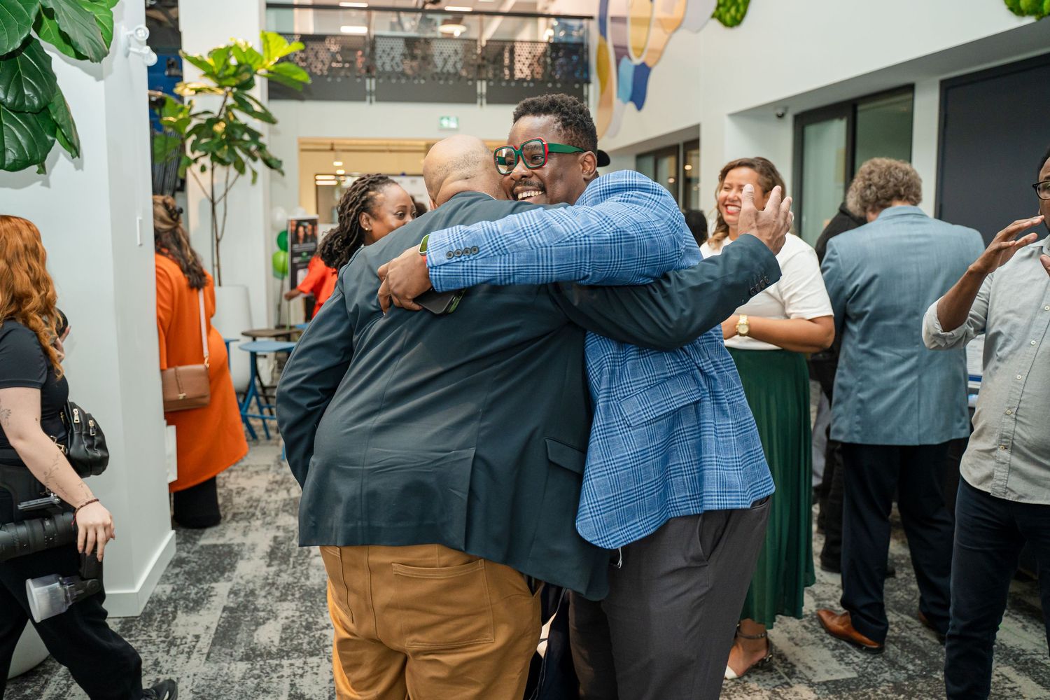 Group of people embracing during a business gathering or celebration event.