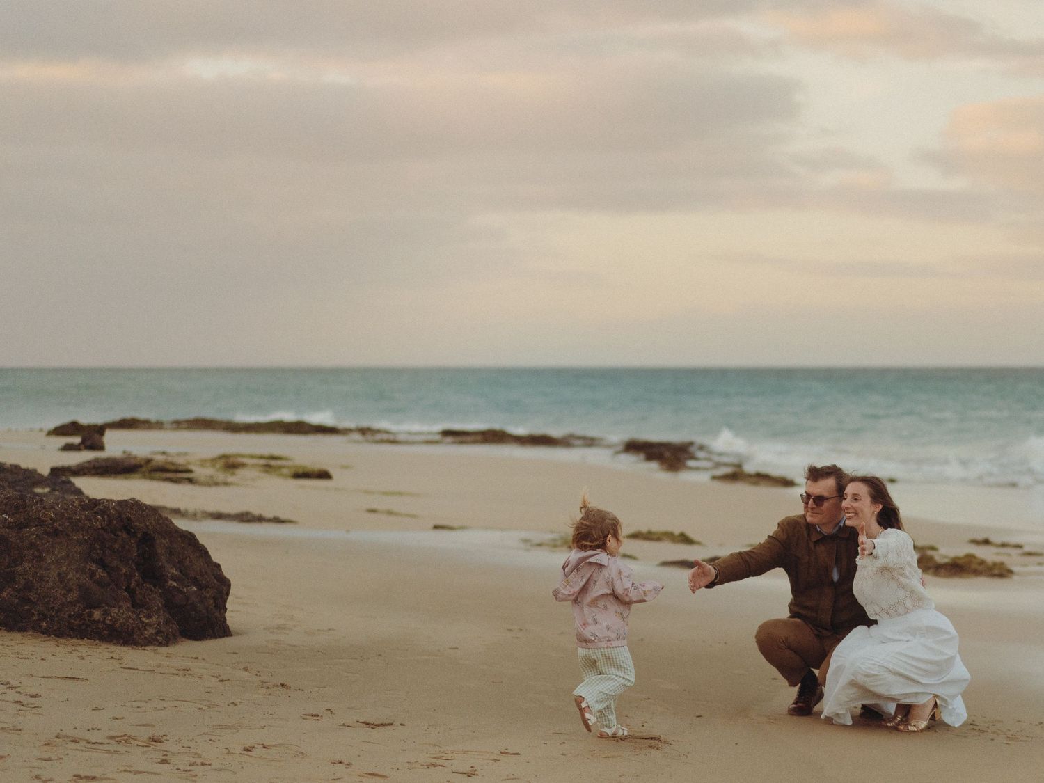 A series of romantic beach wedding photos showing a couple posing at sunset by the ocean.
