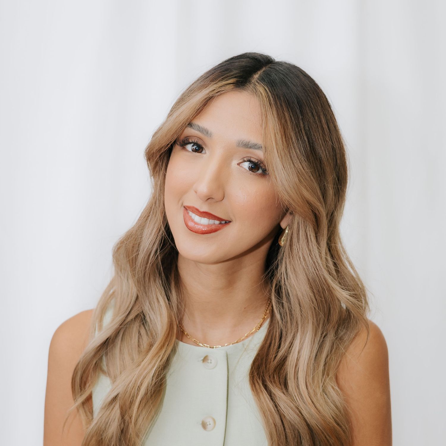 Studio beauty portraits against white background showcasing natural makeup and styled hair.