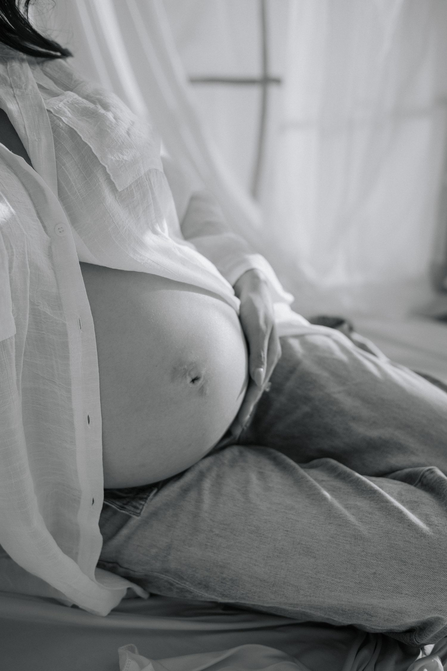 Black and white artistic photo showing soft fabric and bedding in a minimalist style.