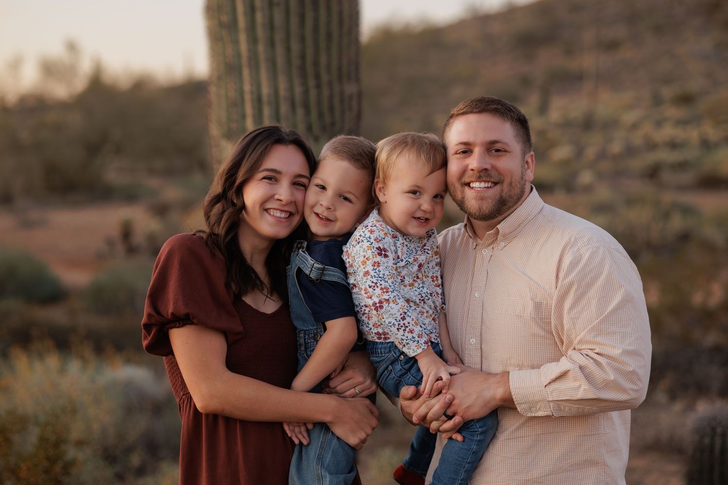 Family portrait in desert setting during golden hour.