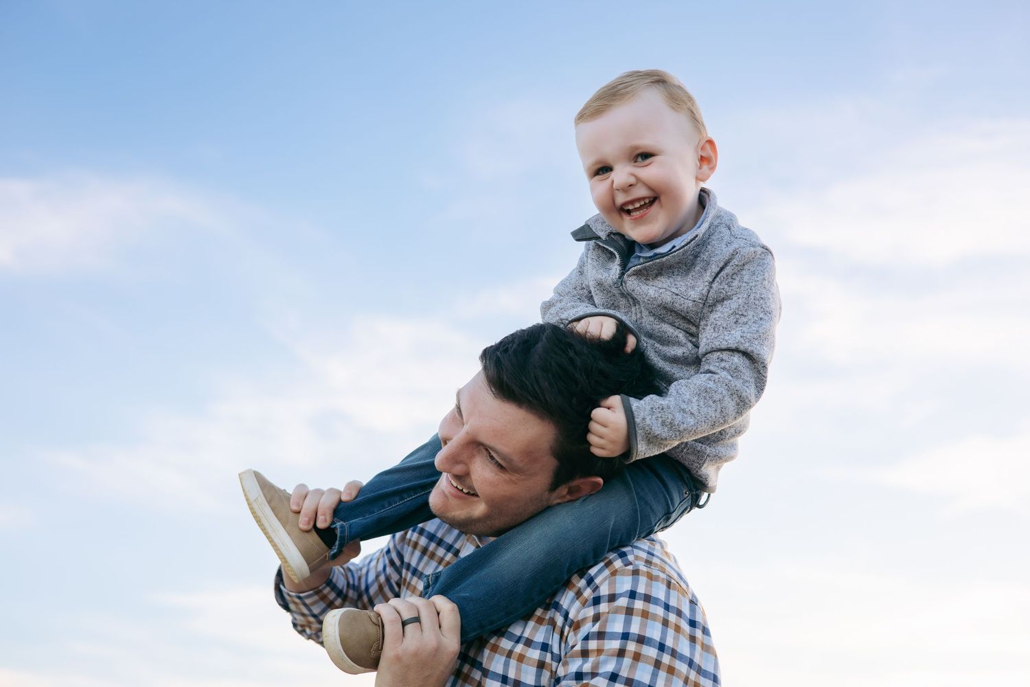 Playful family interactions against blue desert sky.