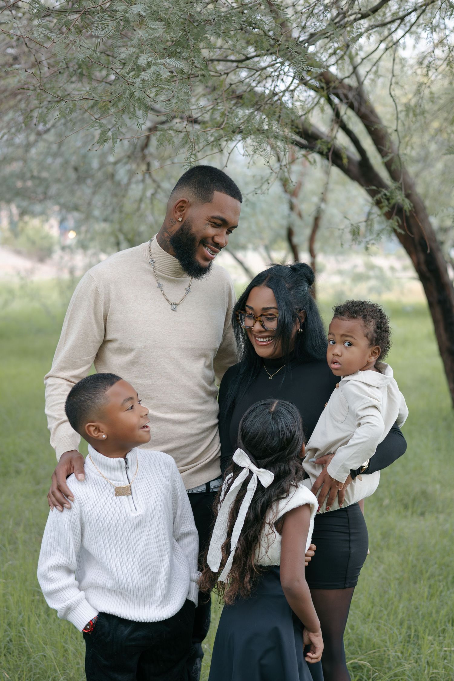 Family enjoying playful moment together in natural outdoor setting.
