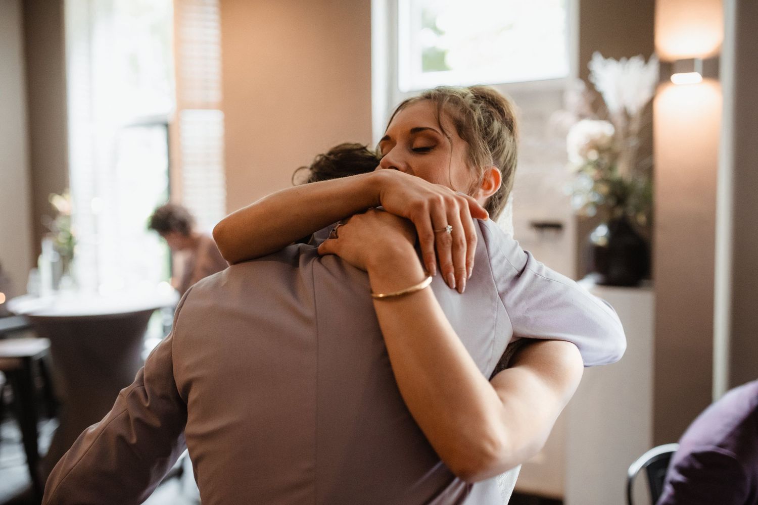 Couples embracing on the dance floor during an intimate wedding reception.