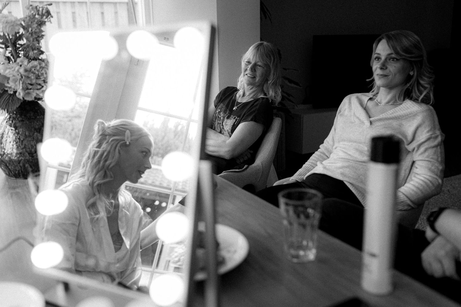Black and white image of wedding preparation with mirror reflections.