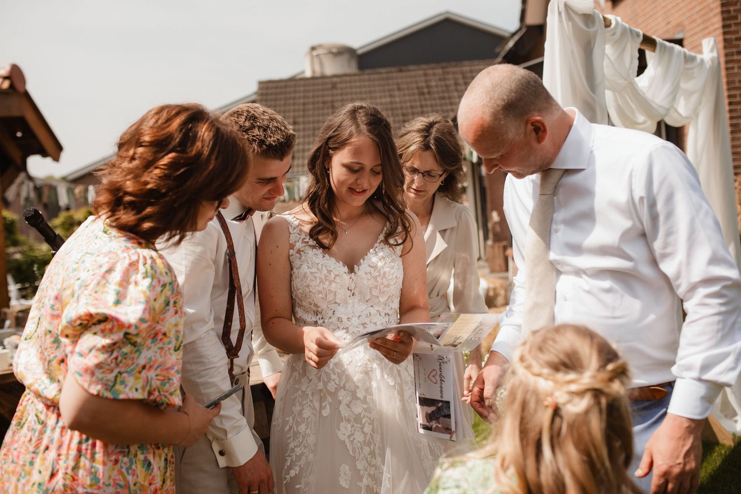 Wedding guests mingle and celebrate during an outdoor summer reception.