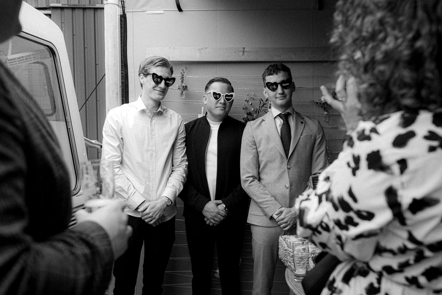 Black and white photograph of wedding ceremony moments with floral decorations.