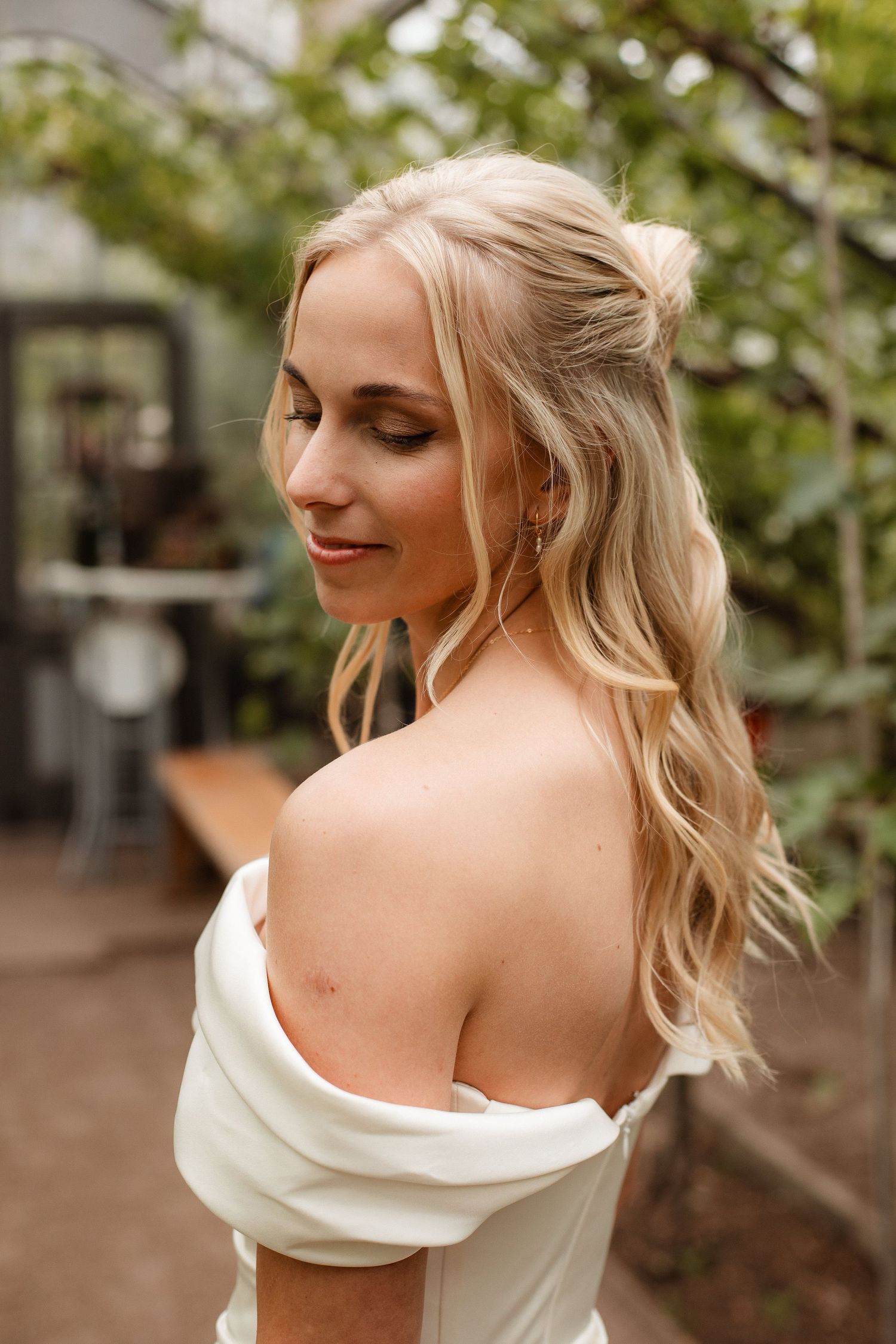 Artistic bridal portraits showing details of an off-shoulder wedding gown.