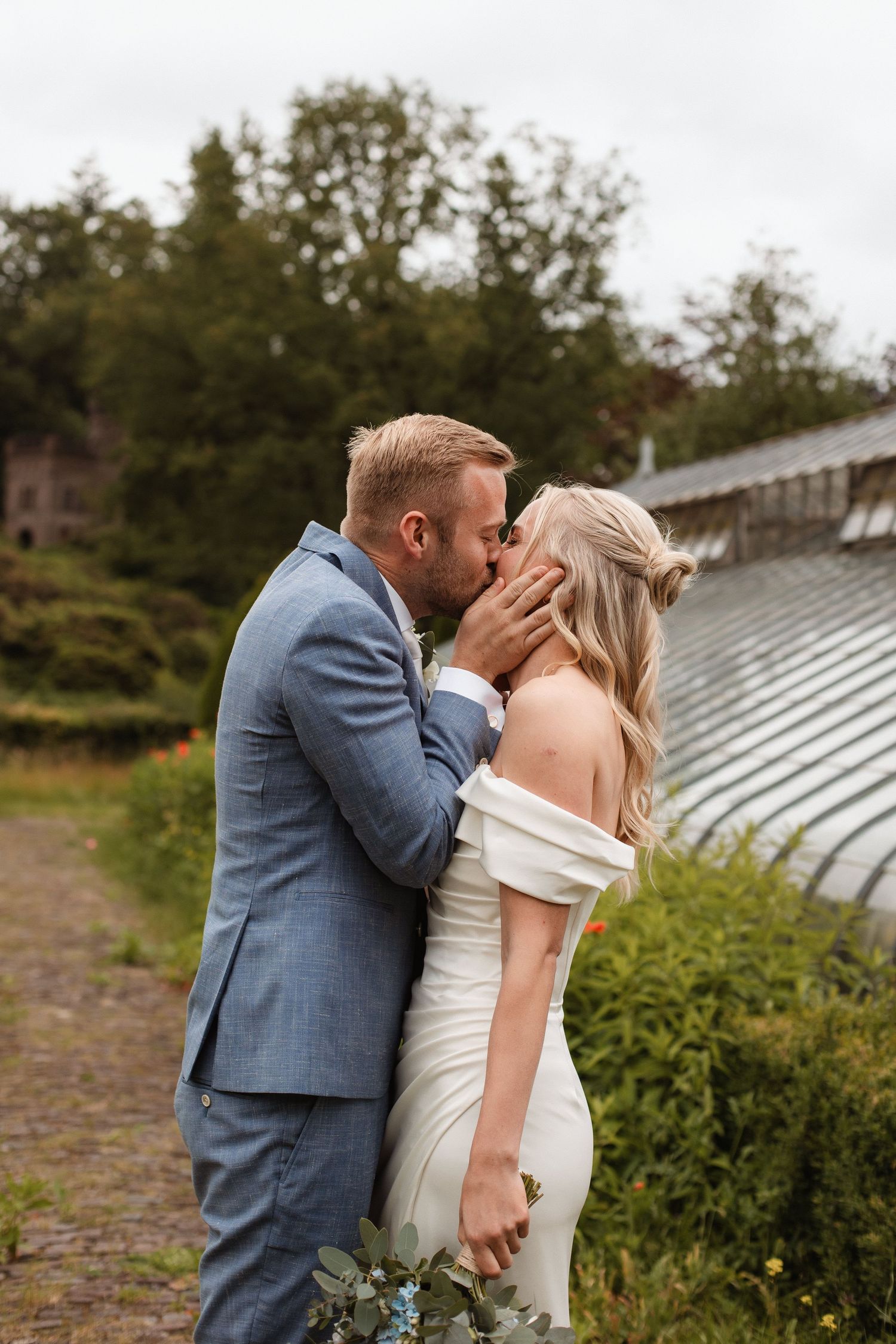 Intimate wedding moment captured in an outdoor garden setting.