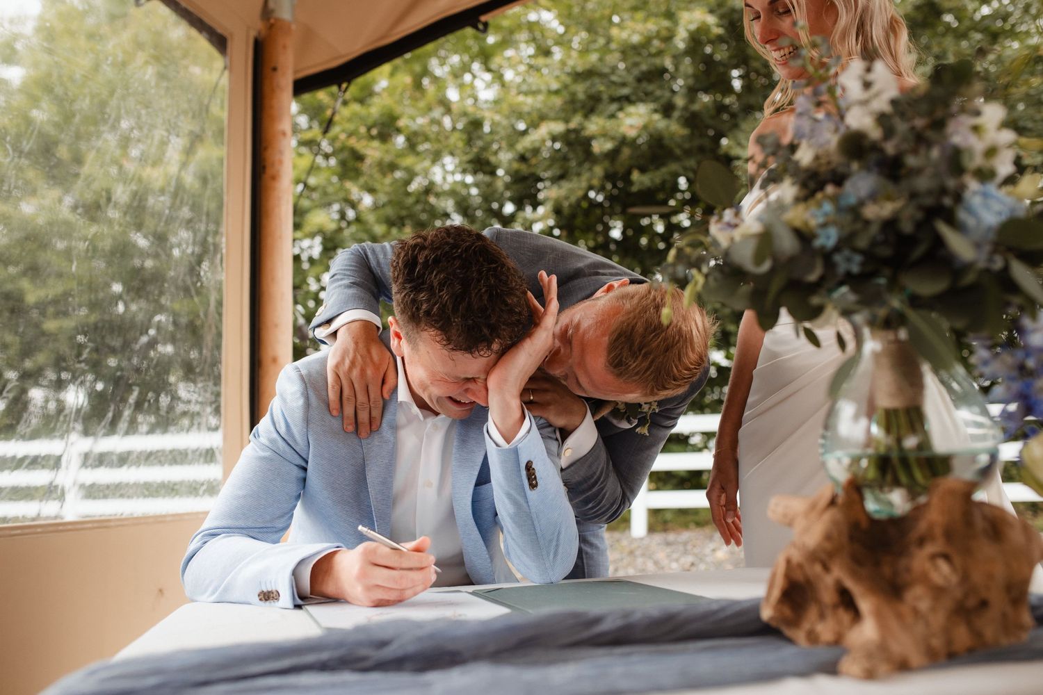 A romantic dance sequence unfolds under a covered outdoor wedding venue with greenery.