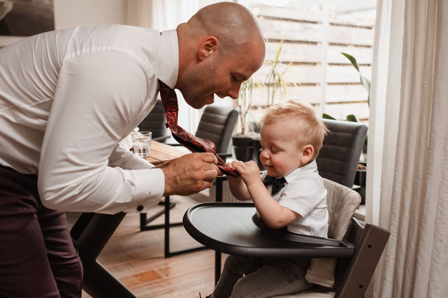 Sweet candid moments shared between loved ones during wedding day preparations.
