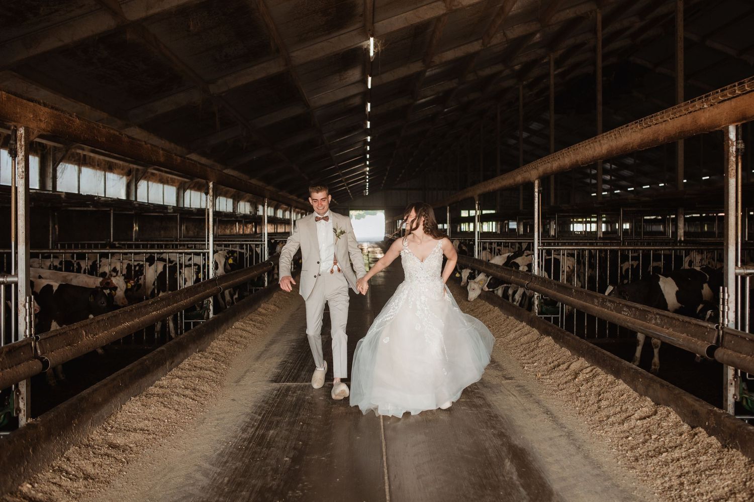 Rustic wedding venue interior with wooden beams and dramatic lighting.
