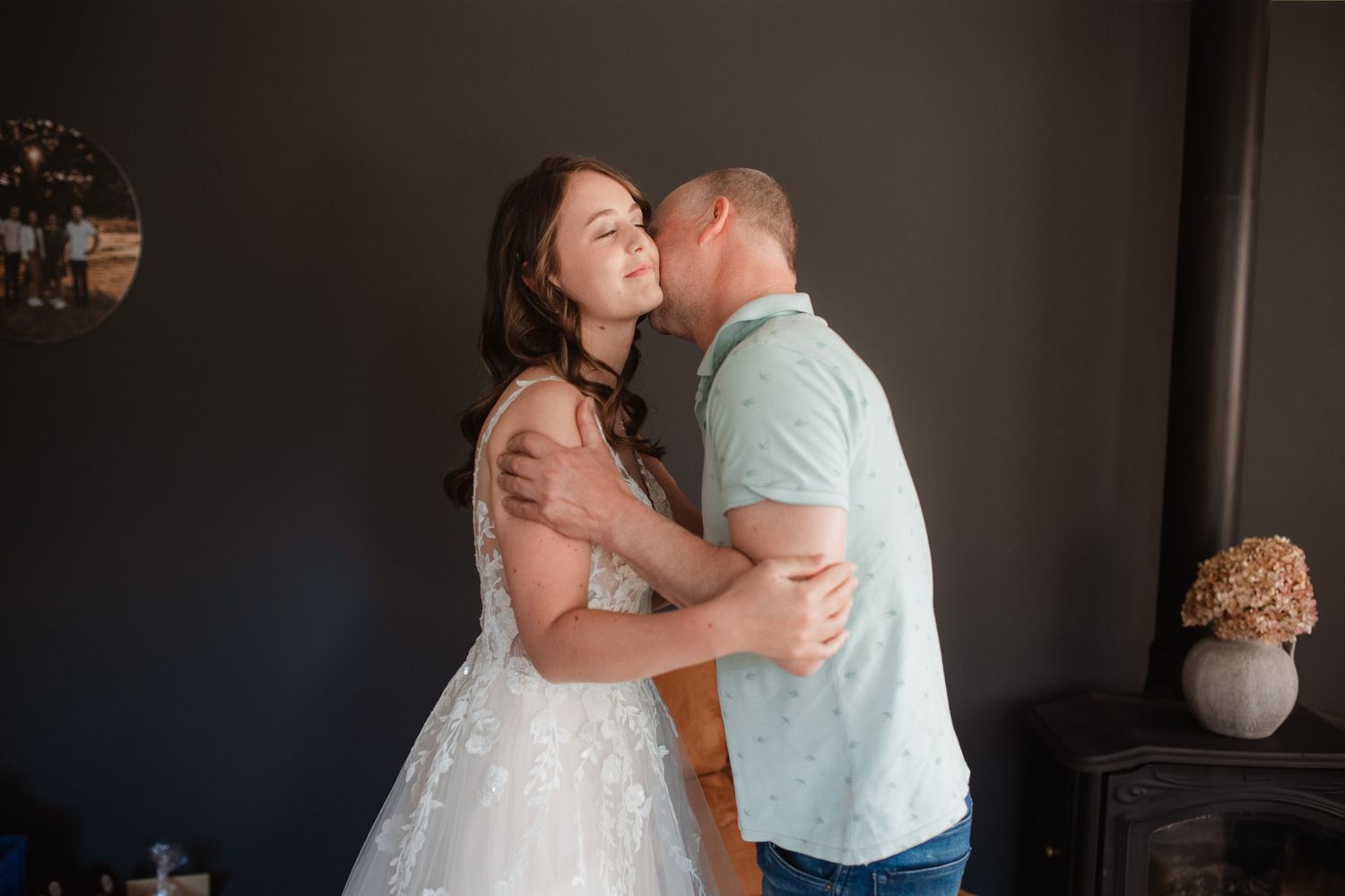 Intimate wedding day moments captured in moody indoor lighting.