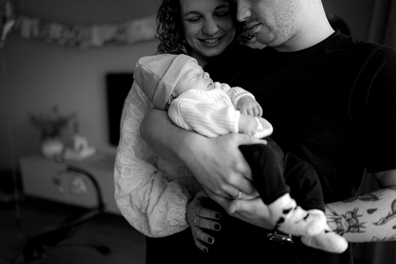 Gezin met pasgeboren baby tijdens een intiem moment.