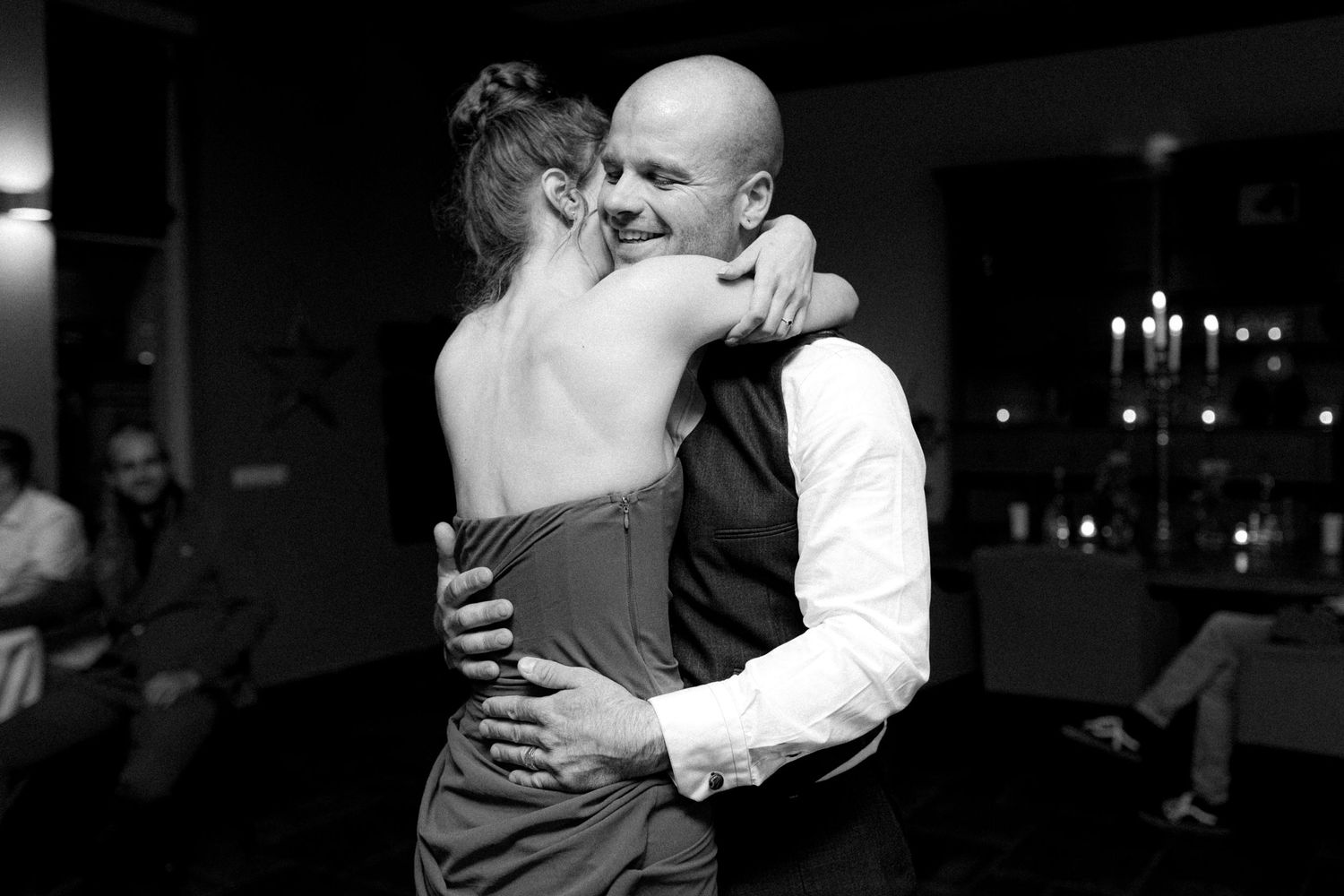 Couples dancing and embracing during evening wedding reception celebrations.