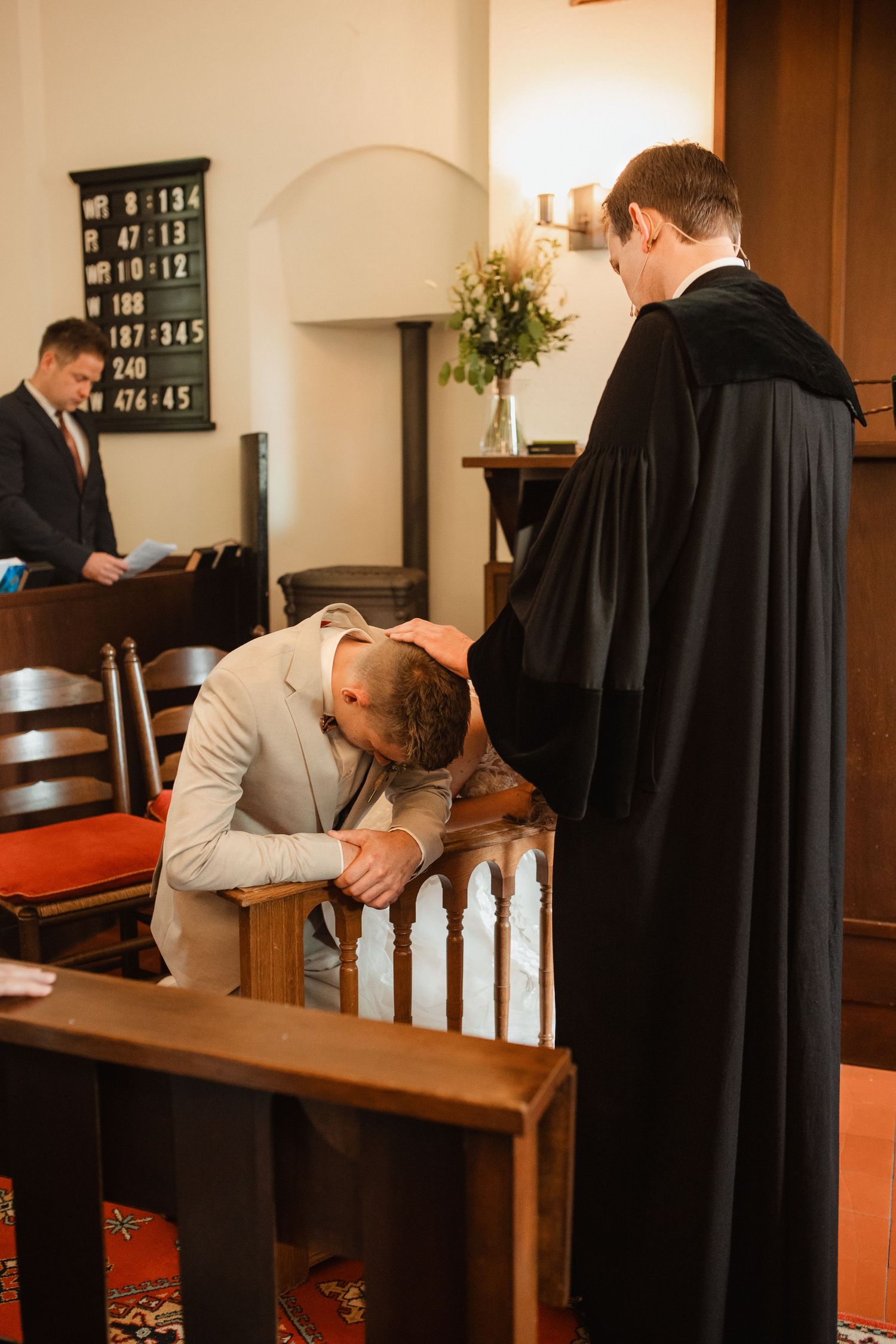 A prayer moment captured in a church setting with wooden pews and warm lighting.
