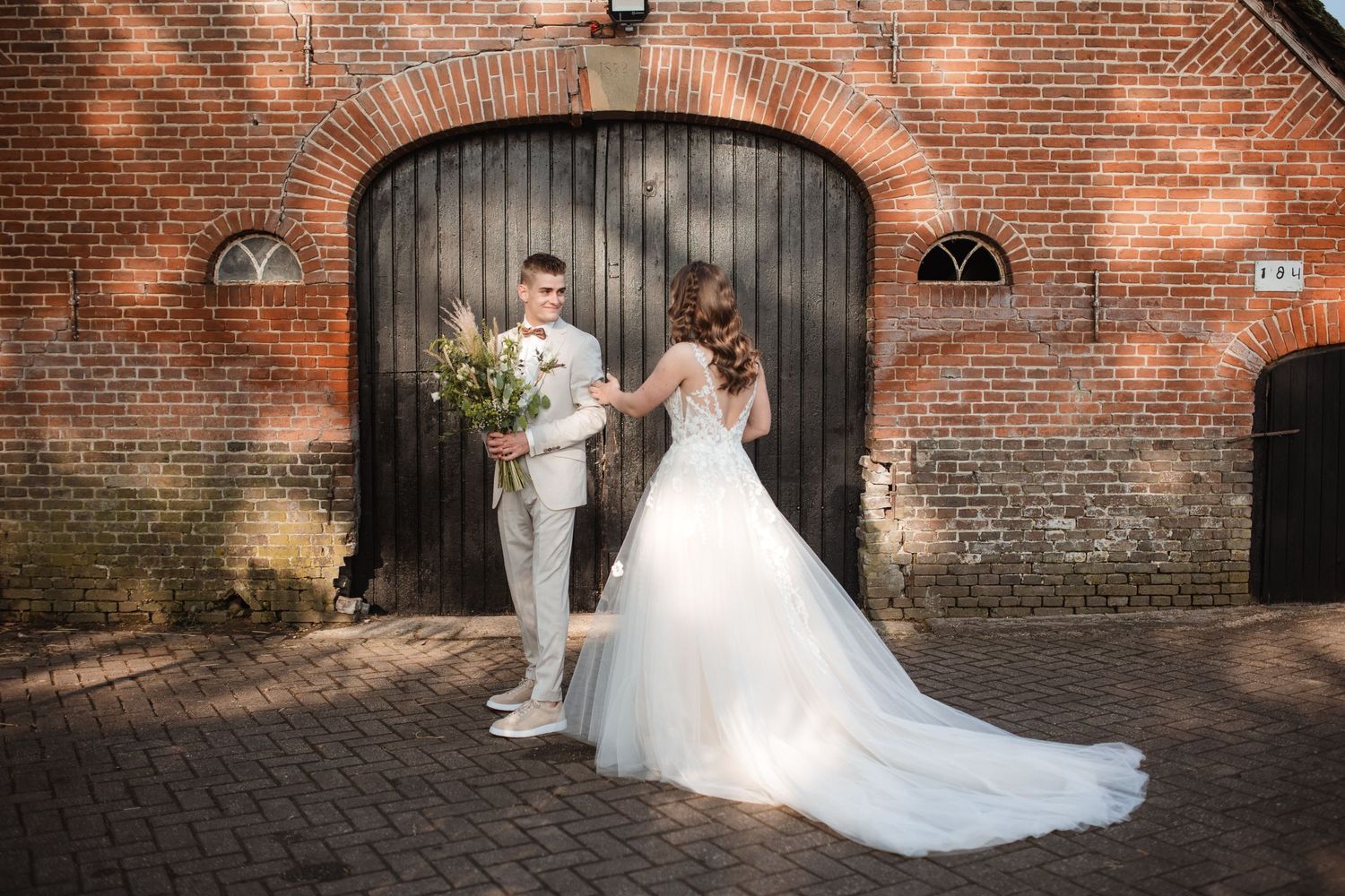 Wedding photography session against historic brick archways and walls.