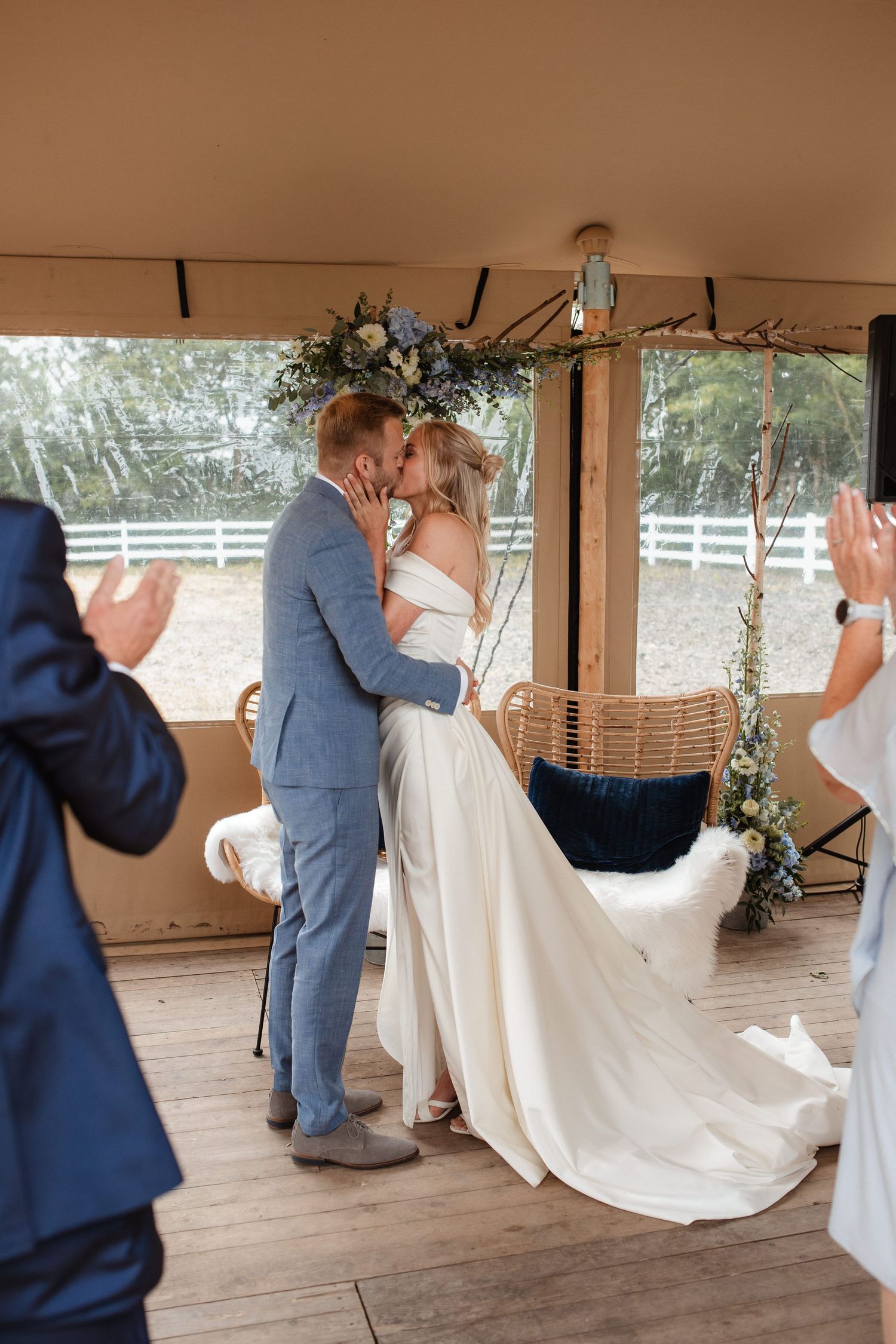 A couple performs a romantic dance sequence in a rustic outdoor wedding venue.