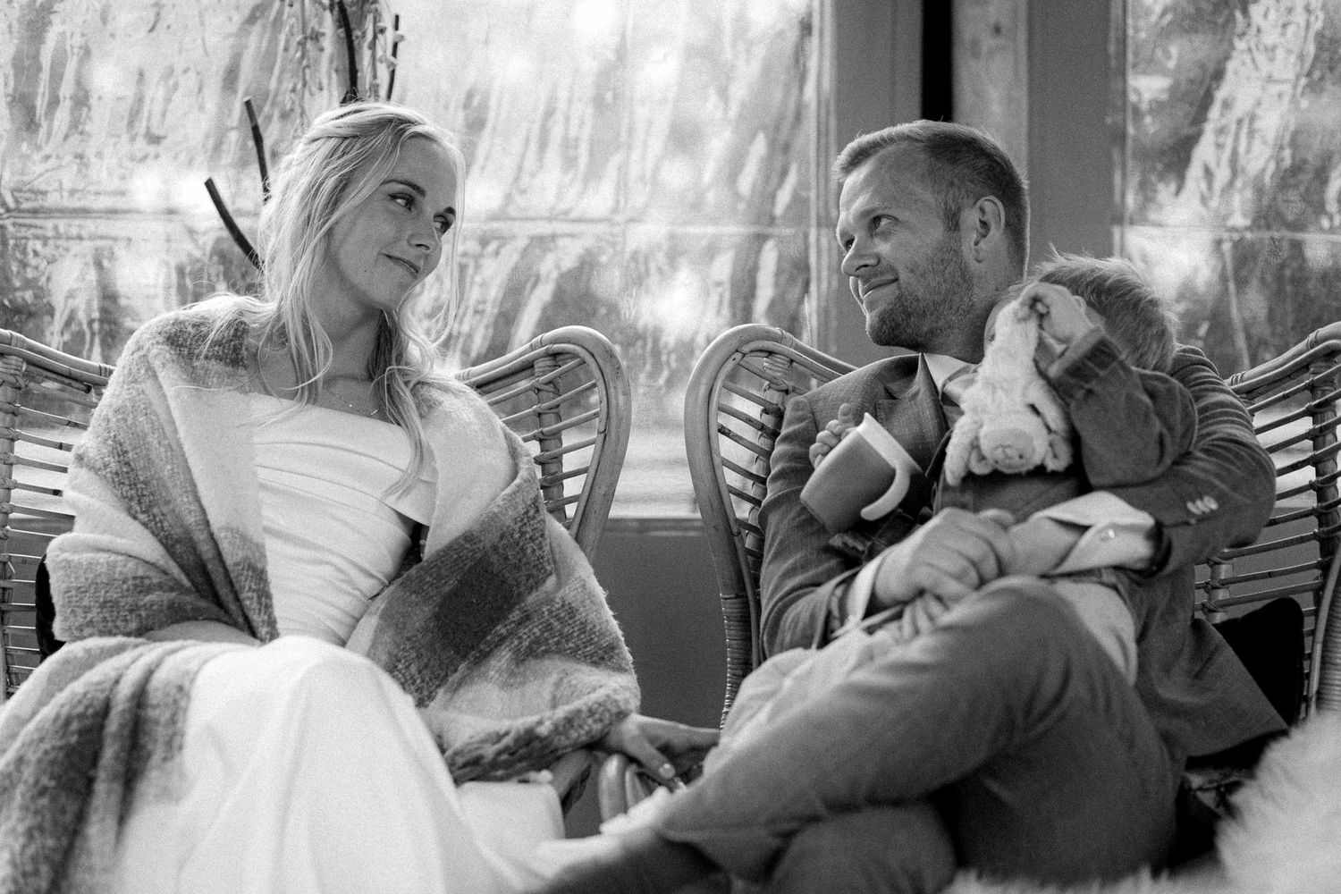 Black and white candid wedding moments captured in a series of emotional photographs.