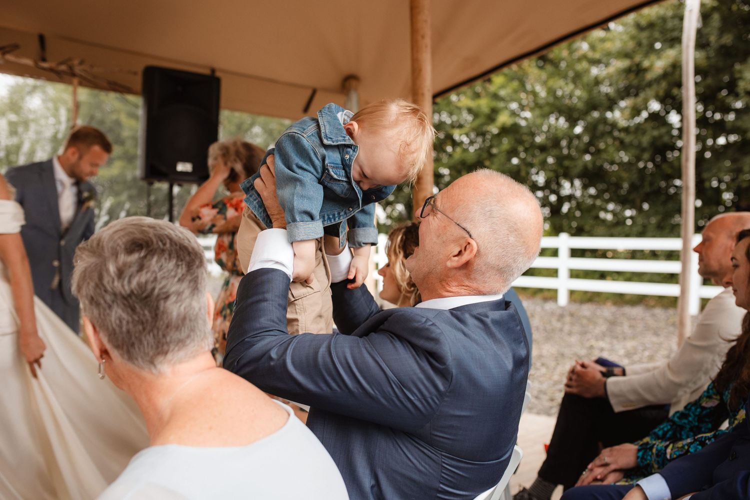 Wedding guests watch and celebrate as the couple performs their first dance.