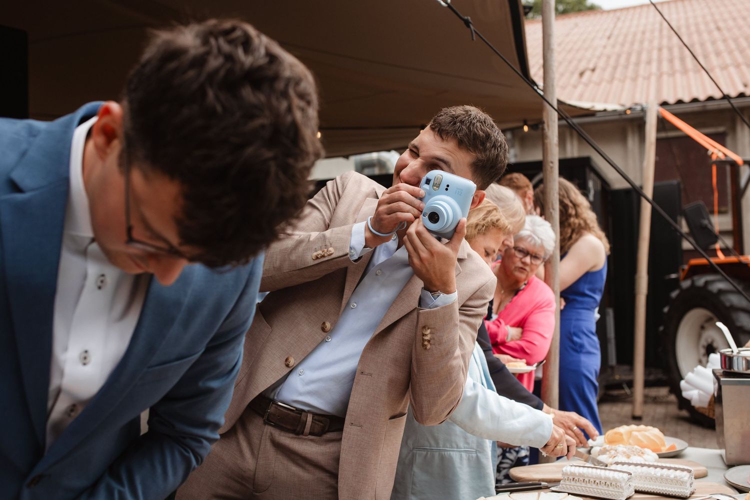 Wedding guests enjoying refreshments and conversation at an outdoor reception.