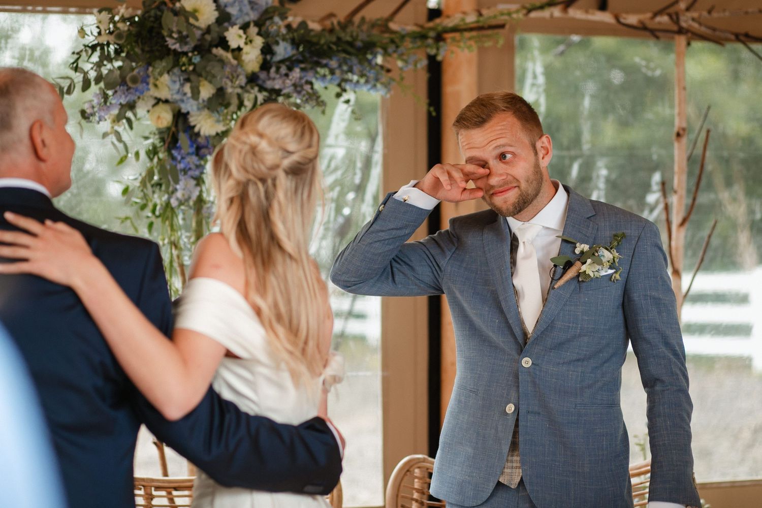 Newlyweds share tender moments during their first dance at an indoor venue.