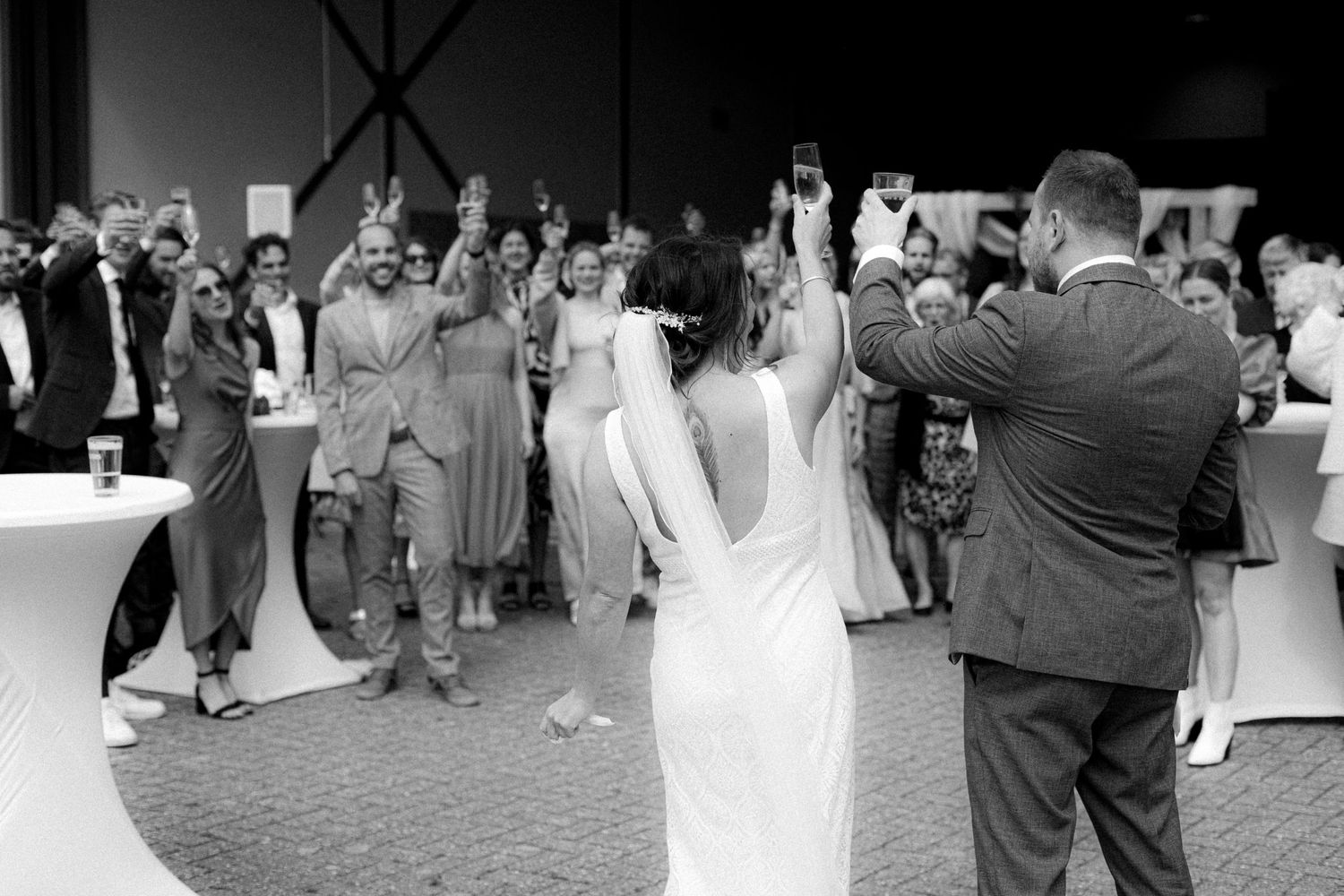Wedding guests dancing and celebrating on a reception dance floor.