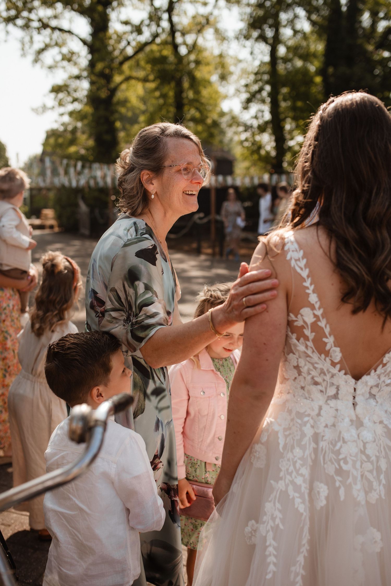 Wedding guests share joyful moments during an outdoor celebration.