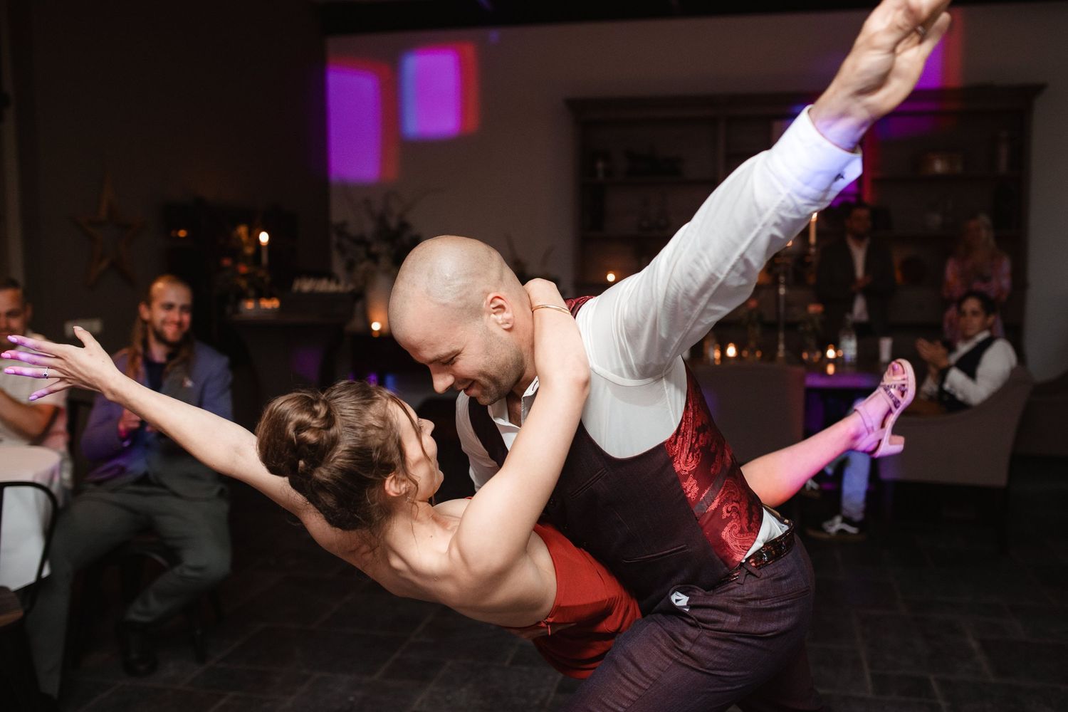 Dynamic dance moves captured during lively wedding reception party.