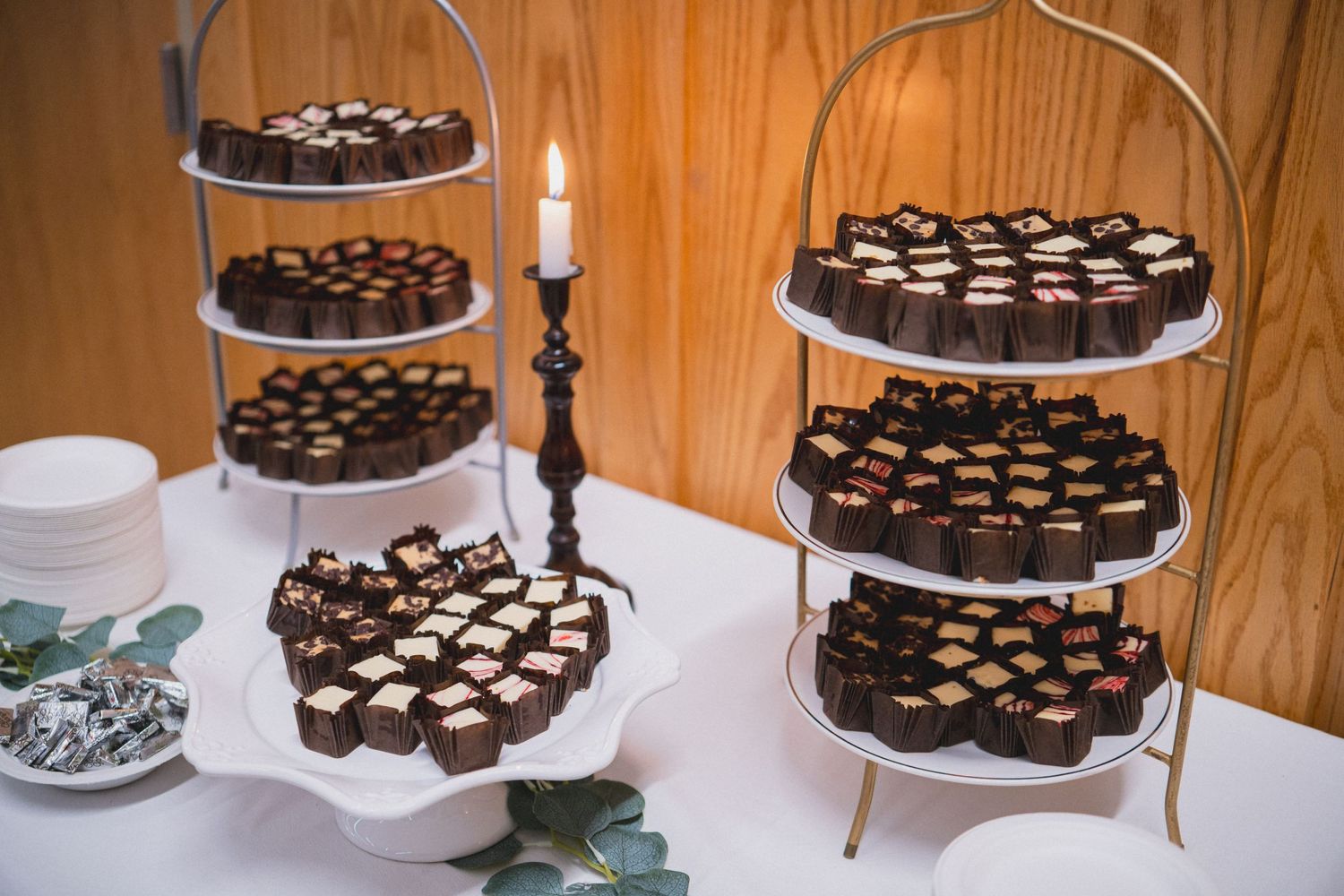 Tiered stands displaying chocolate desserts and treats at an event.