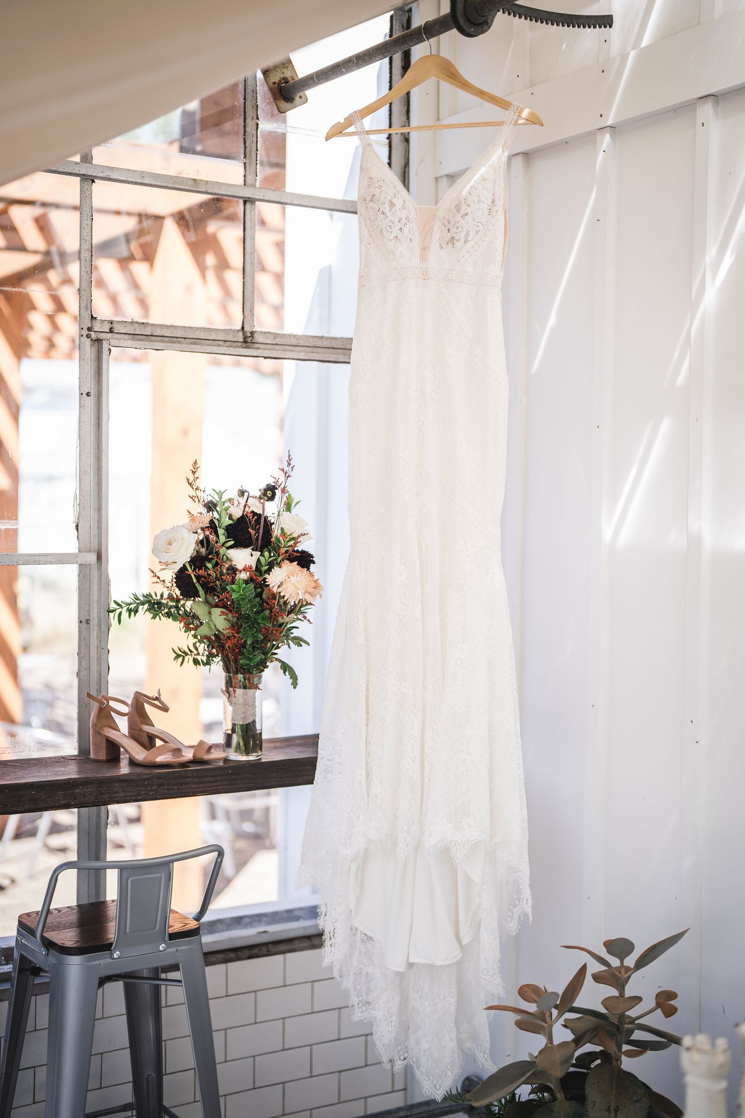 White curtains and floral arrangements decorate an indoor space with natural lighting.