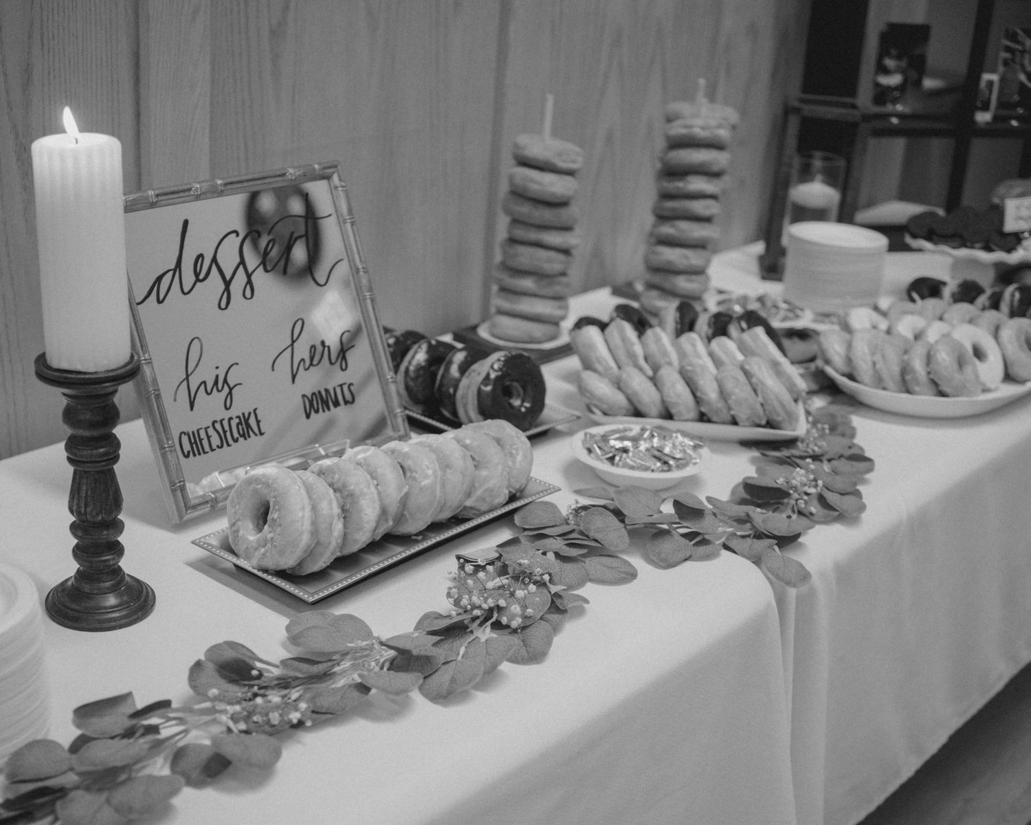 A decorated buffet table with candles and place settings for an elegant event.