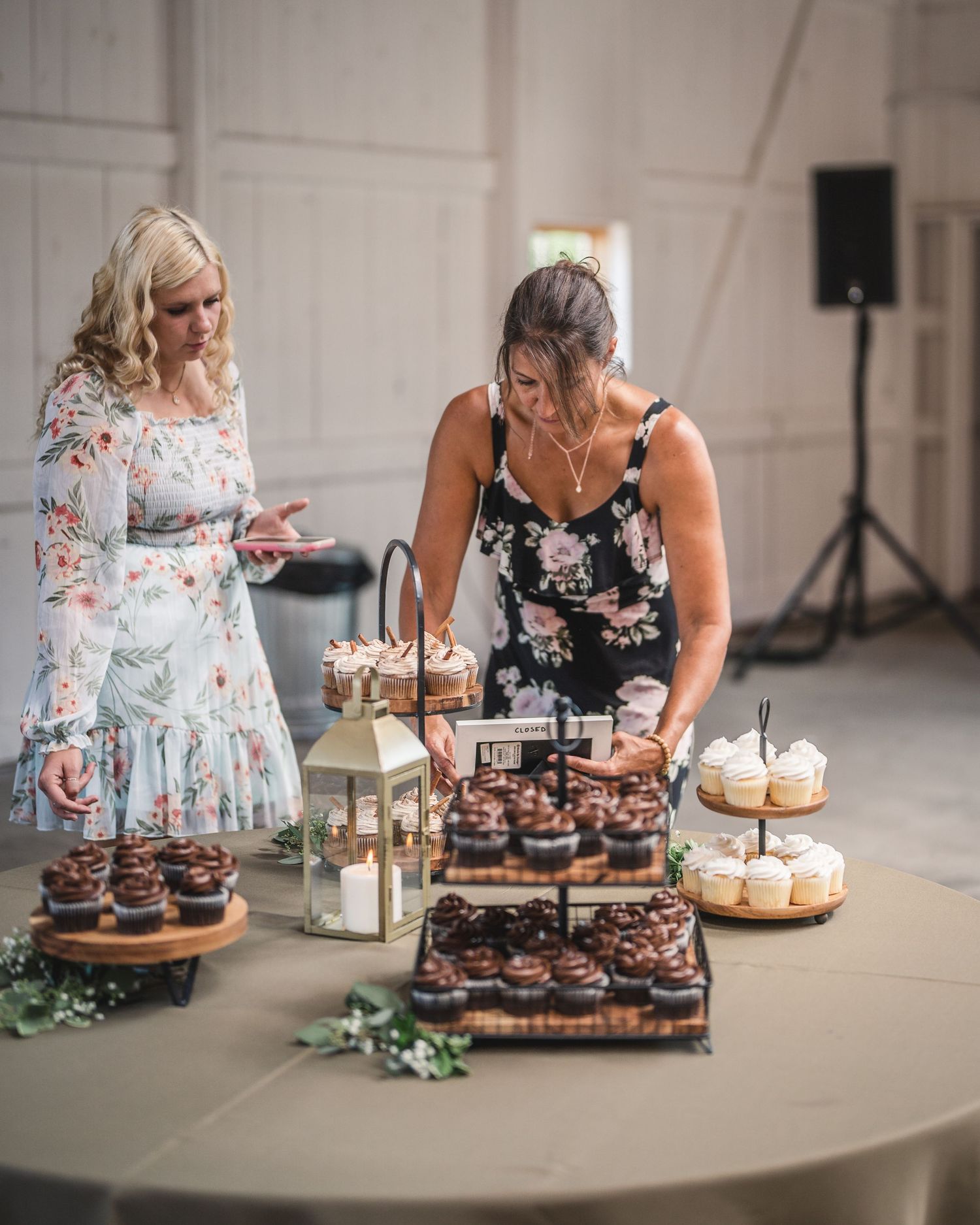 Wedding dessert table displays with cupcakes and treats arranged on tiered stands.