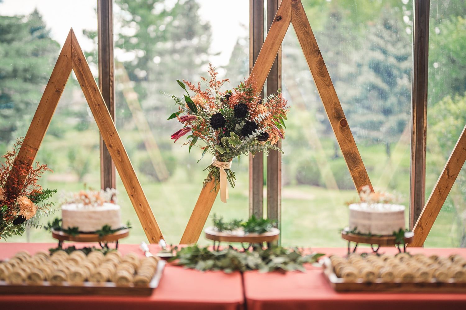 Wooden hexagon arch decorated with floral arrangements for outdoor wedding ceremony.