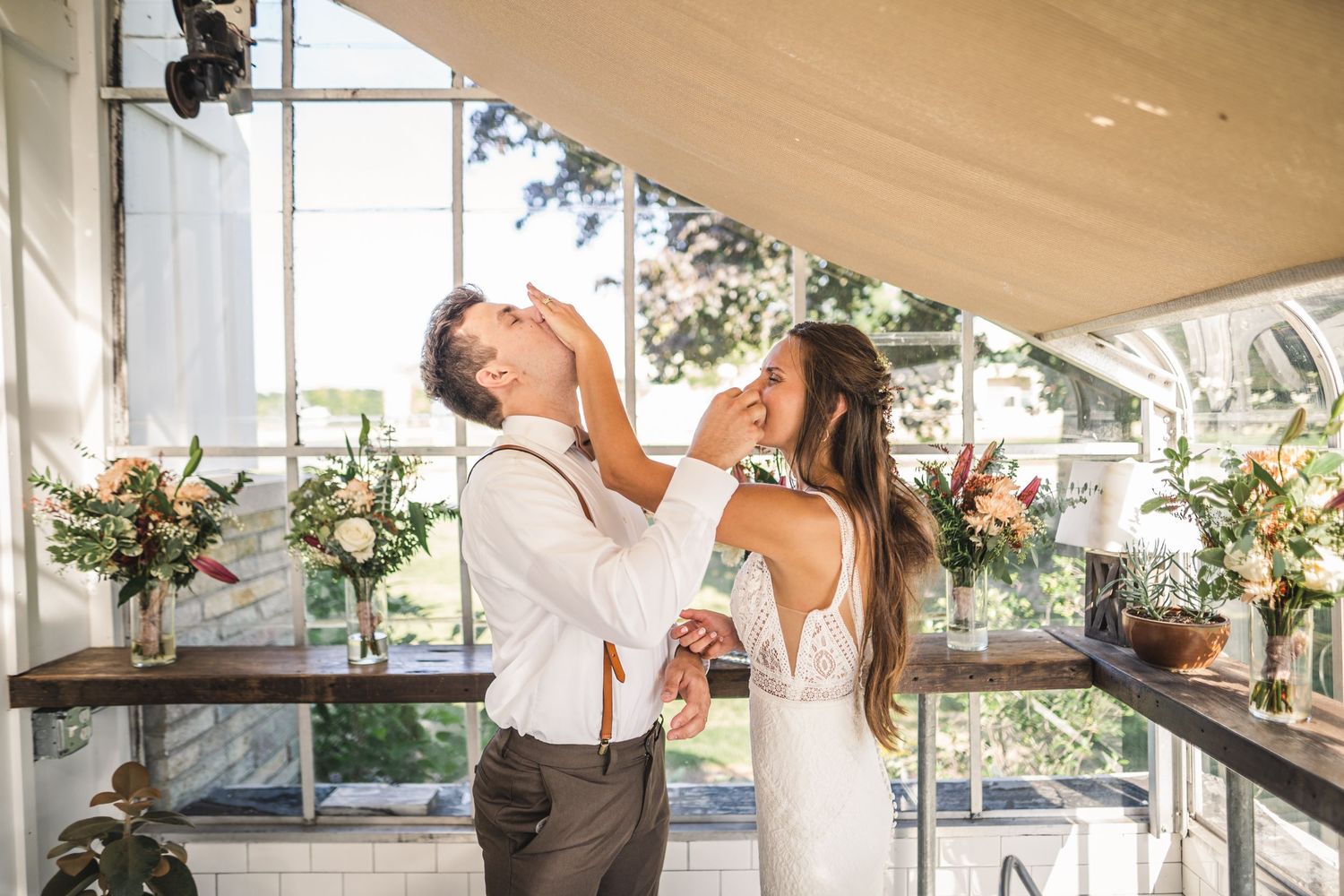 Reception venue decorated with elegant draping and natural lighting for a wedding celebration.