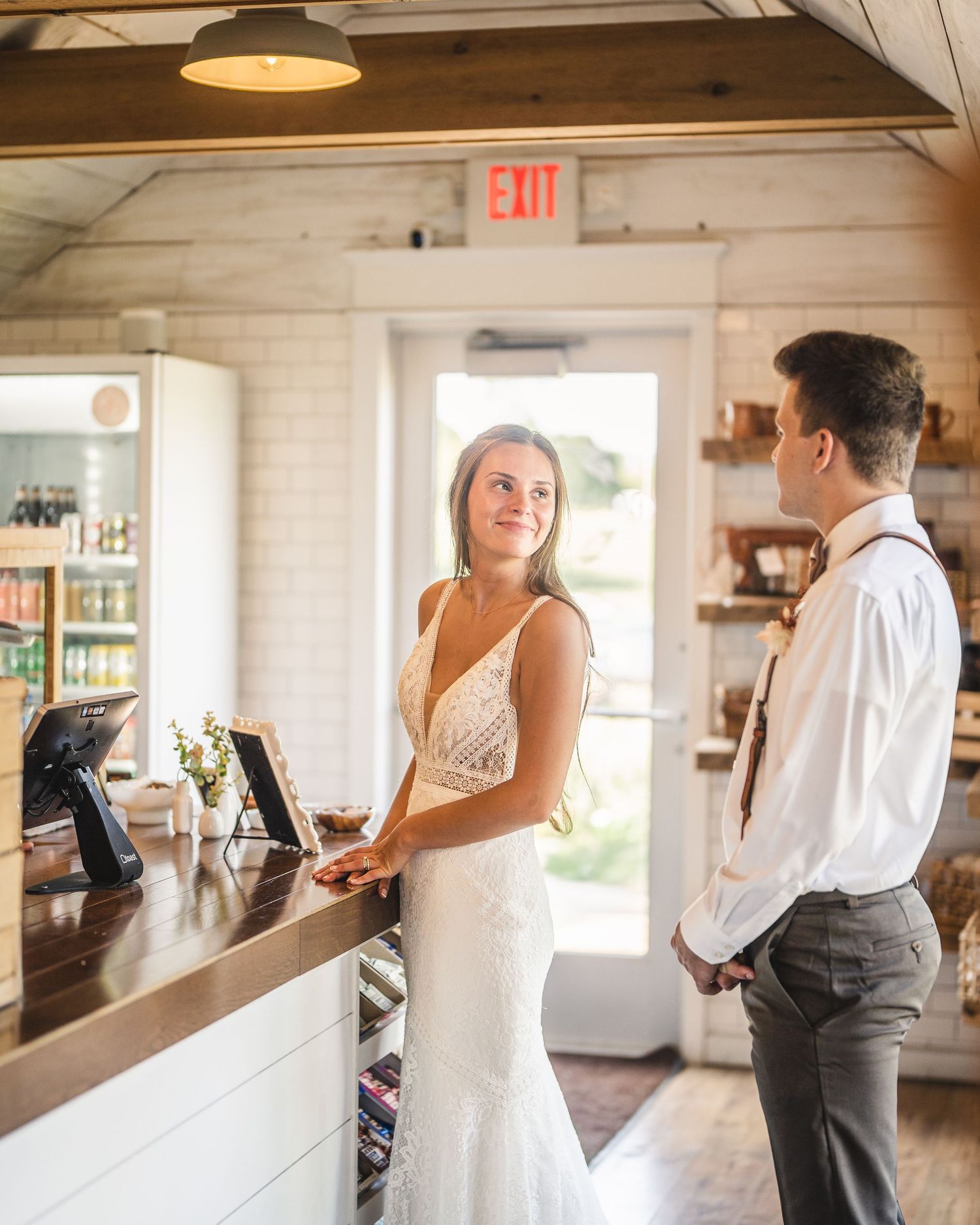 Interior shots of a rustic barn venue with newlyweds sharing intimate moments.