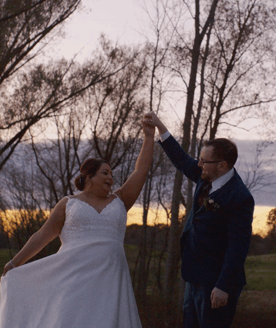 Wedding film of a bride and groom dancing at sunset outdoors, with the brides veil blowing romantically in the breeze.
