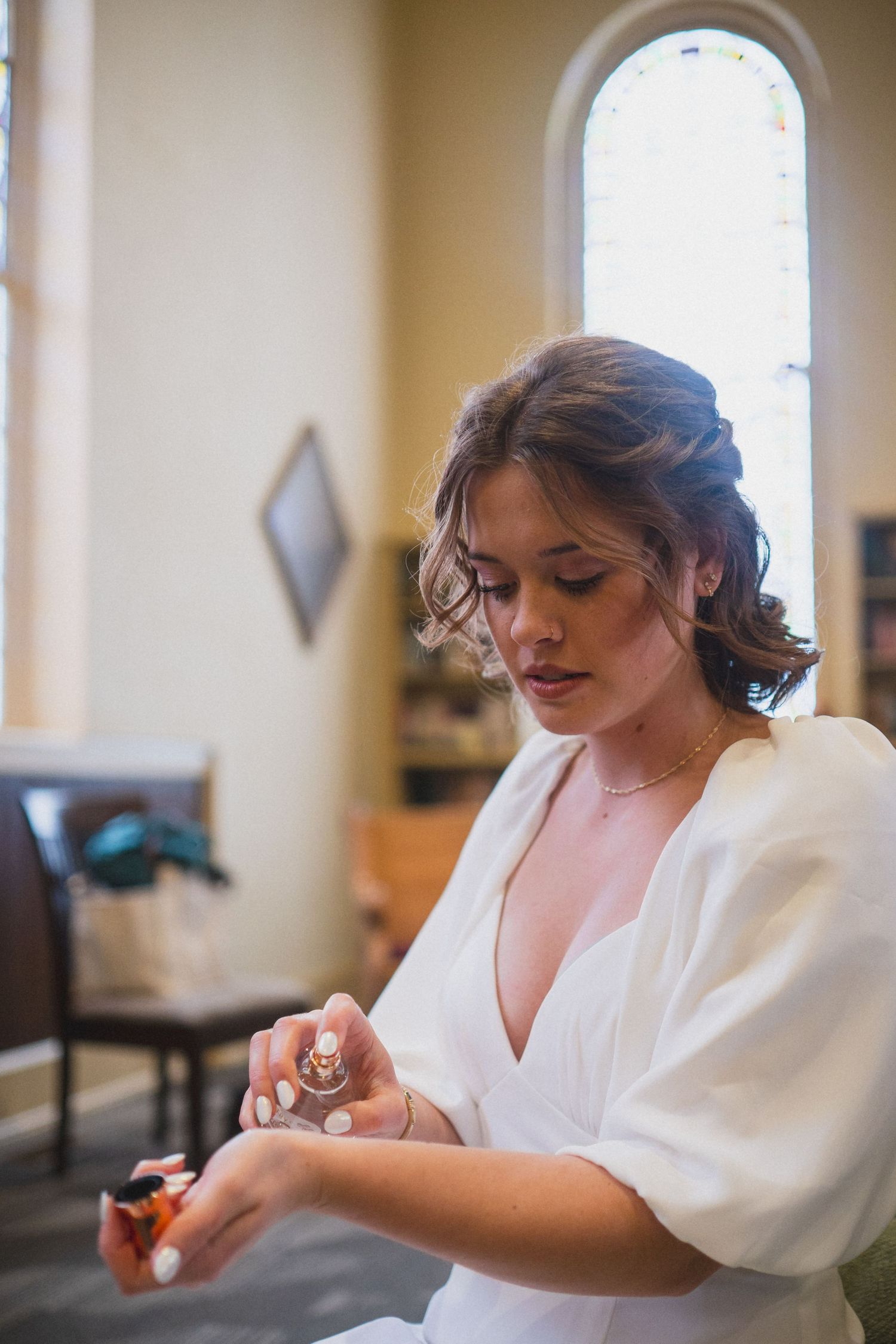 Wedding preparation scene showing someone in a white robe getting ready.