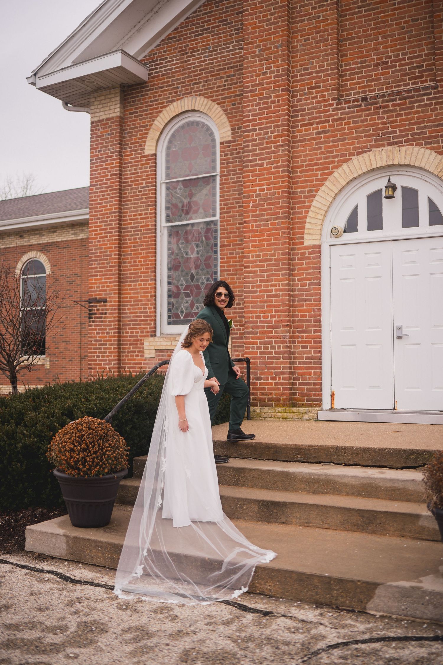 Series of wedding photos showing playful moments outside a historic brick church.
