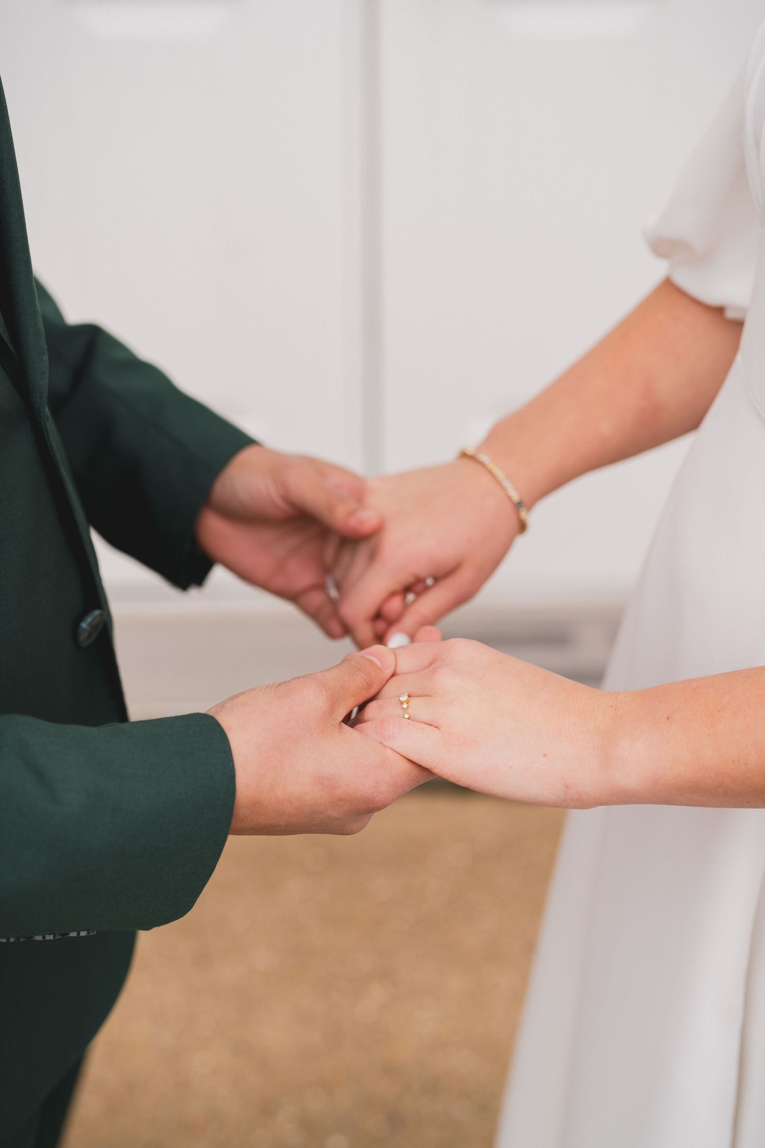Close-up sequence of hands exchanging wedding rings during a ceremony.