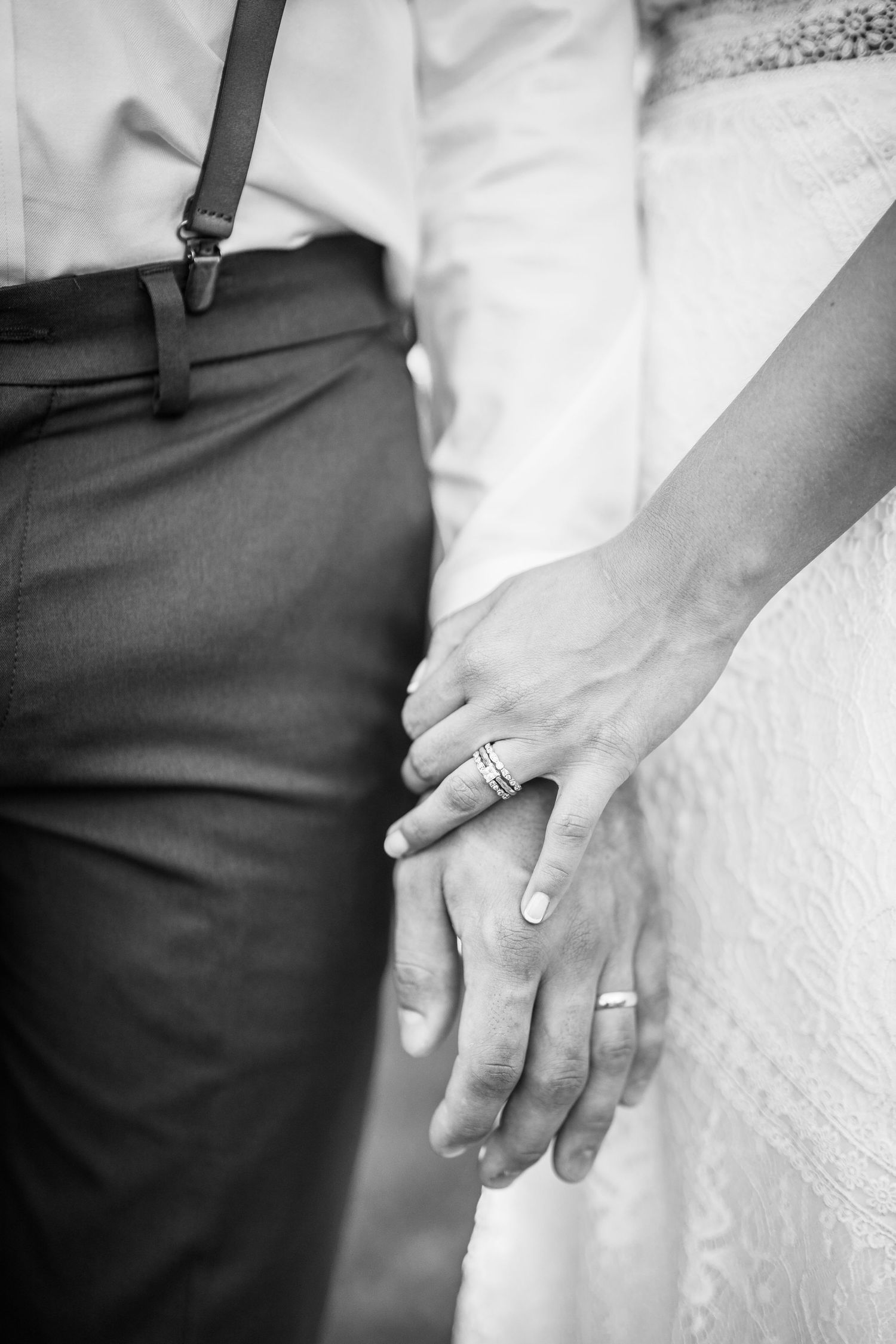 Black and white close-up shots of newlyweds holding hands showing their wedding rings.