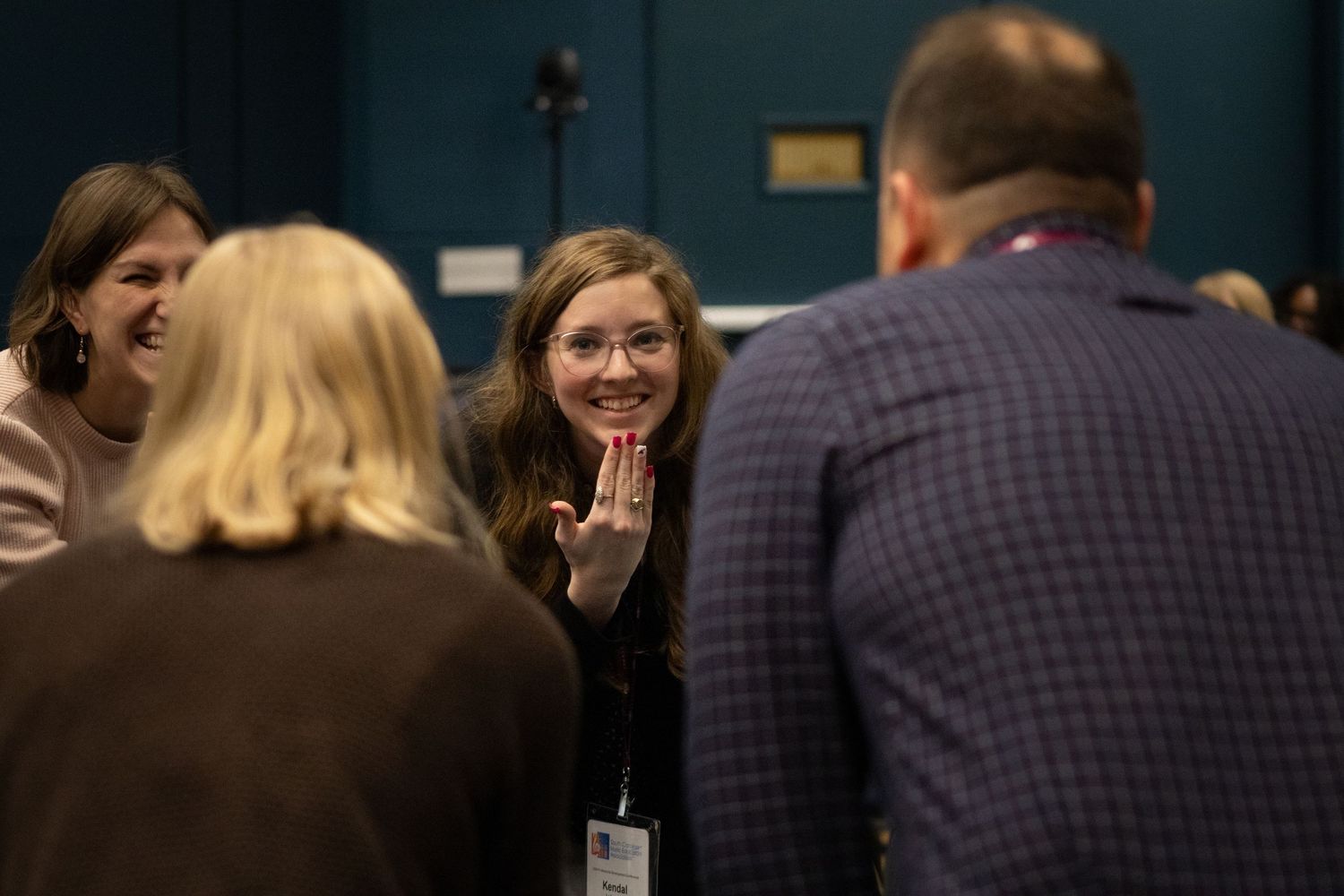 Group engaged in animated discussion during a professional conference or meeting.