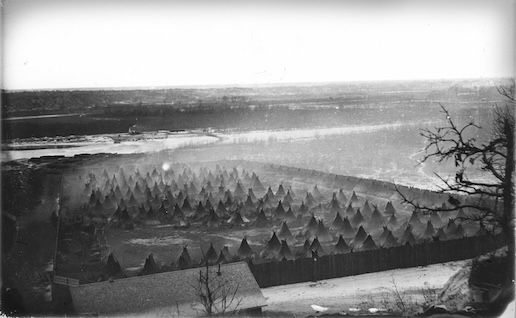 The military concentration camp for Dakota people below Fort Snelling, 1862, photographed by Benjamin Franklin Upton. After the U.S.-Dakota War, 1,600 Dakota people, mostly women and children, were force-marched to this place. Most of those families had not participated in the war and some had actually protected almost 300 people captured during the war. They suffered malnutri- tion and disease, and also endured violence at the hands of soldiers and civilians.