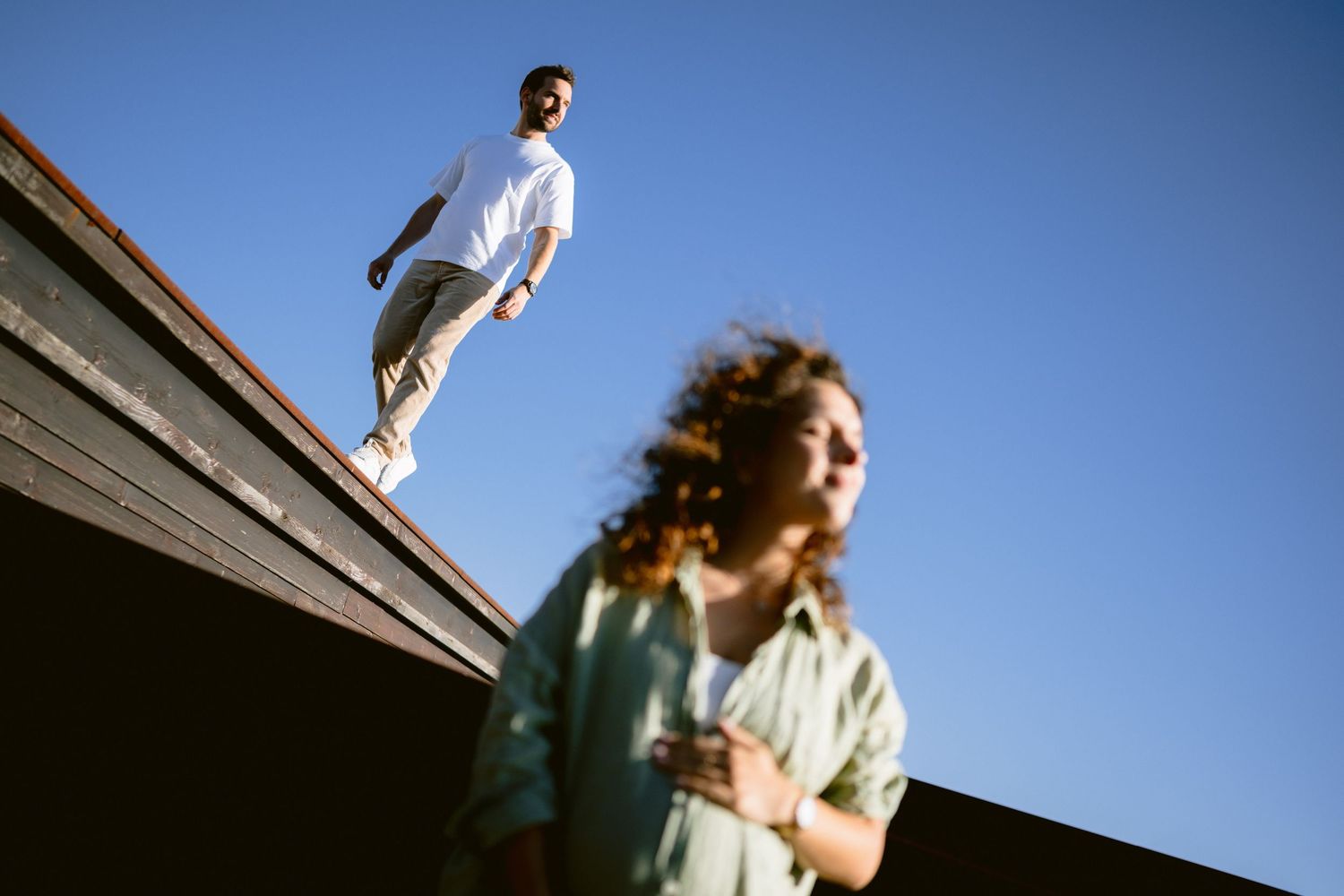Candid family moments captured against bright blue sky.
